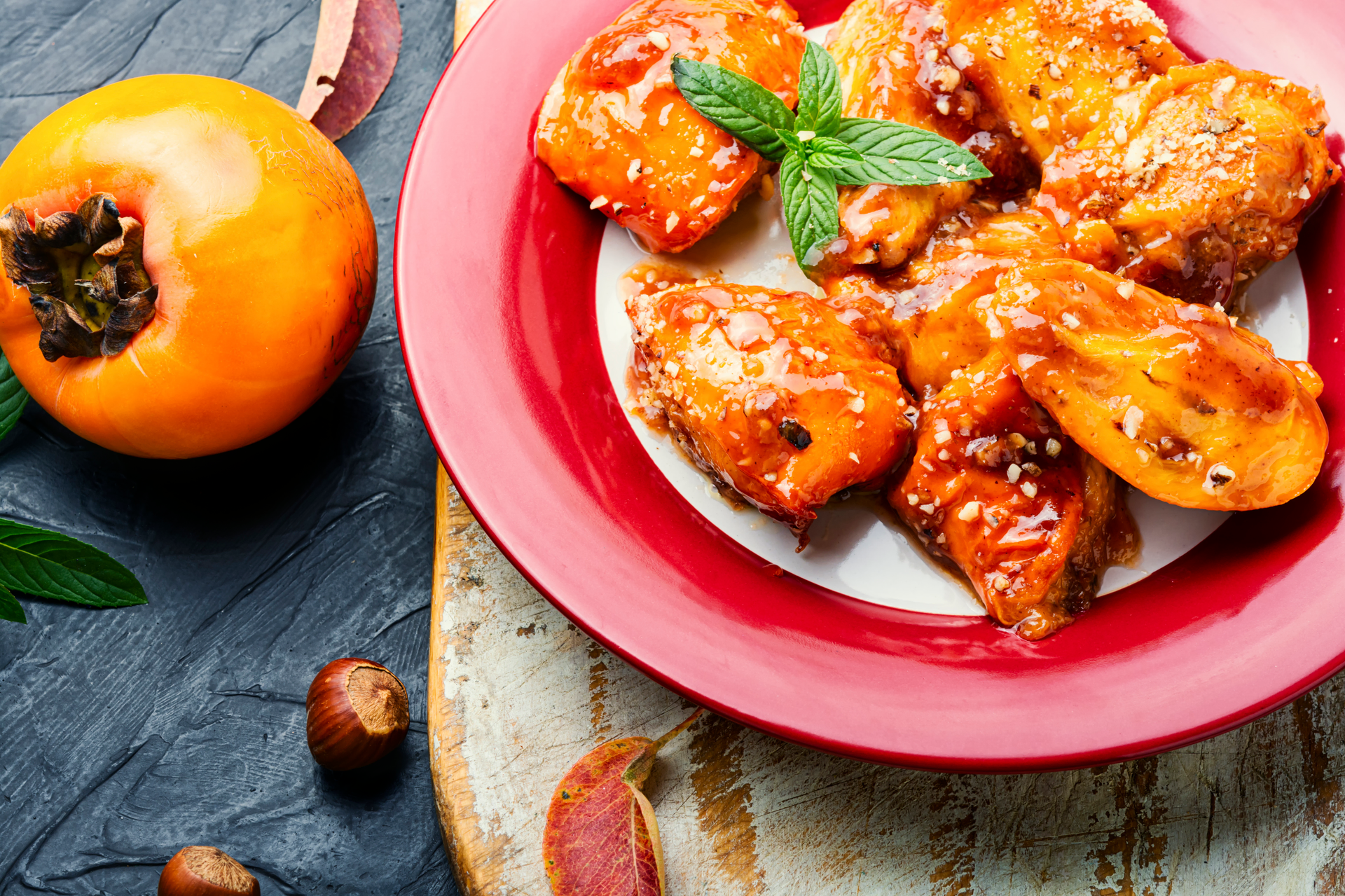 Overhead flat-lay of all ingredients for Citrus-Glazed Tunisian Harissa Chicken with Orange Zest laid out on a kitchen surface.