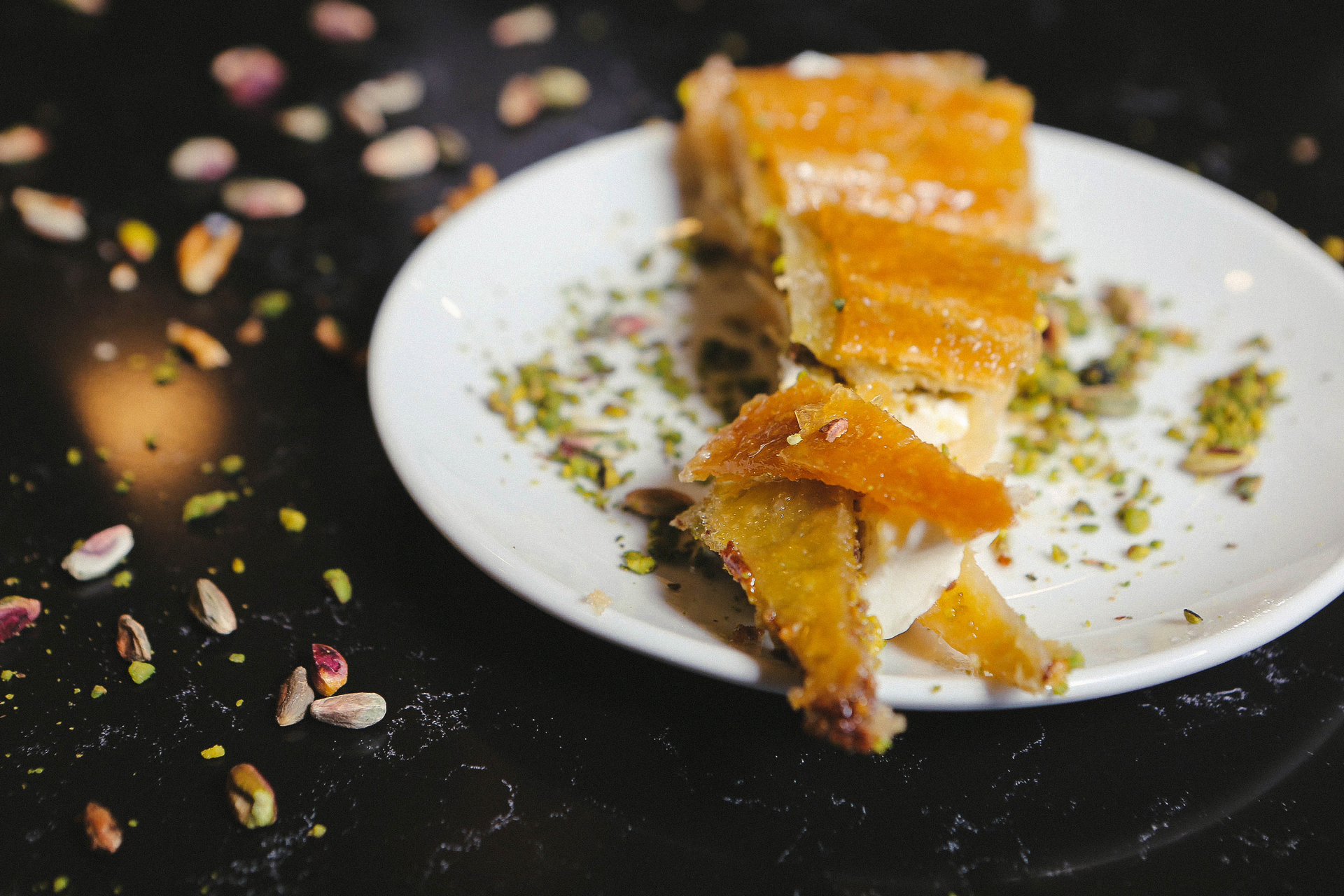 Overhead flat-lay of all ingredients for Citrus-Spiced Egyptian Lemon Baklava with Almond Infusion laid out on a kitchen surface.