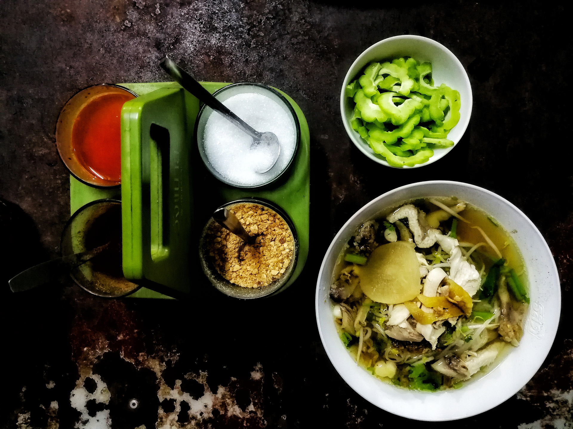 Overhead flat-lay of all ingredients for Citrus Zest Vietnamese Pho Bo with Fresh Herbs Infusion laid out on a kitchen surface.