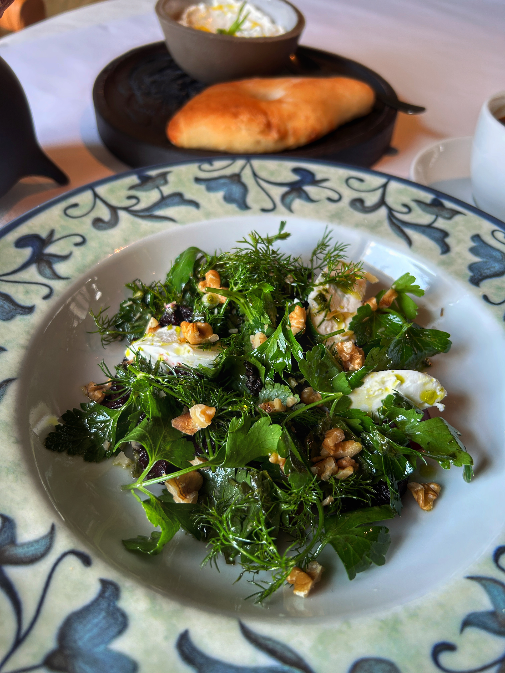 Overhead flat-lay of all ingredients for Citrusy Italian Arugula Salad with Lemon Parmigiano Dressing laid out on a kitchen surface.