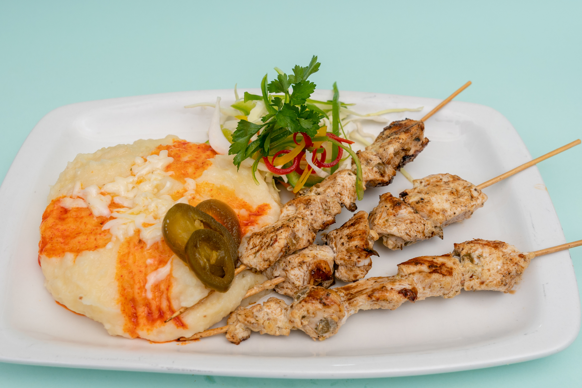 Overhead flat-lay of all ingredients for Citrusy Lebanese Shish Tawook with Garlic Dip laid out on a kitchen surface.