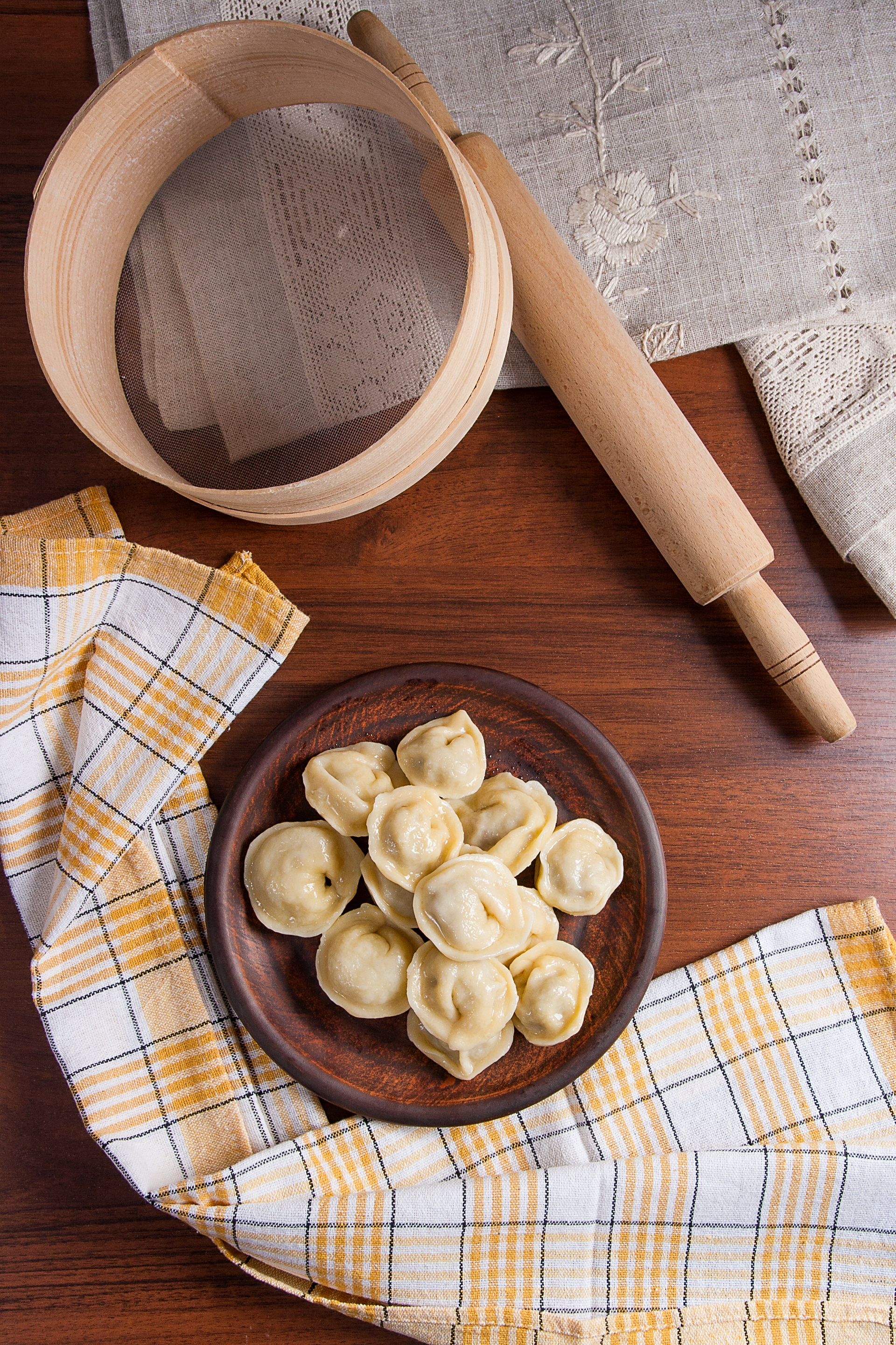 Overhead flat-lay of all ingredients for Classic Russian Pelmeni laid out on a kitchen surface.