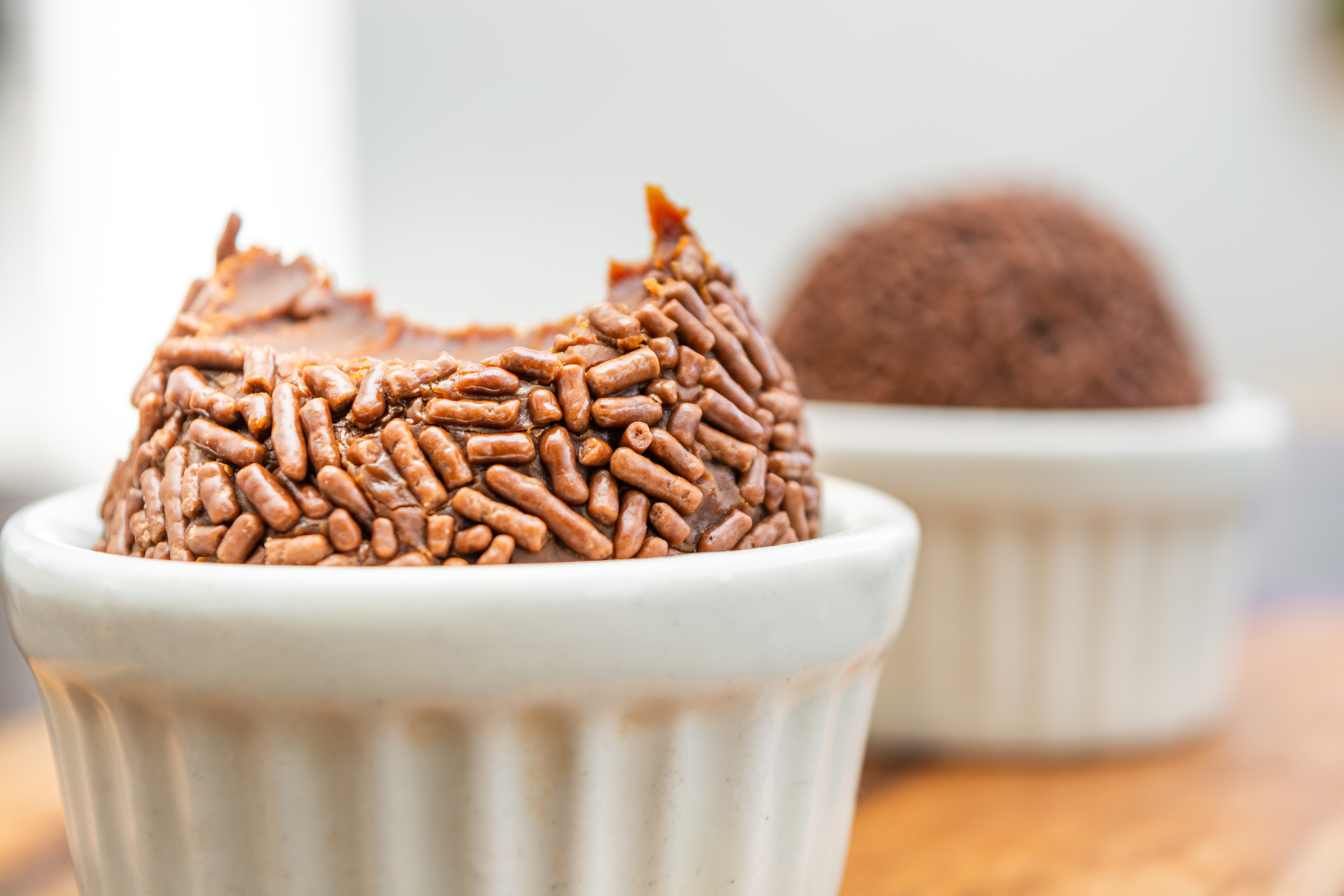 Overhead flat-lay of all ingredients for Creamy Brazilian Brigadeiro laid out on a kitchen surface.