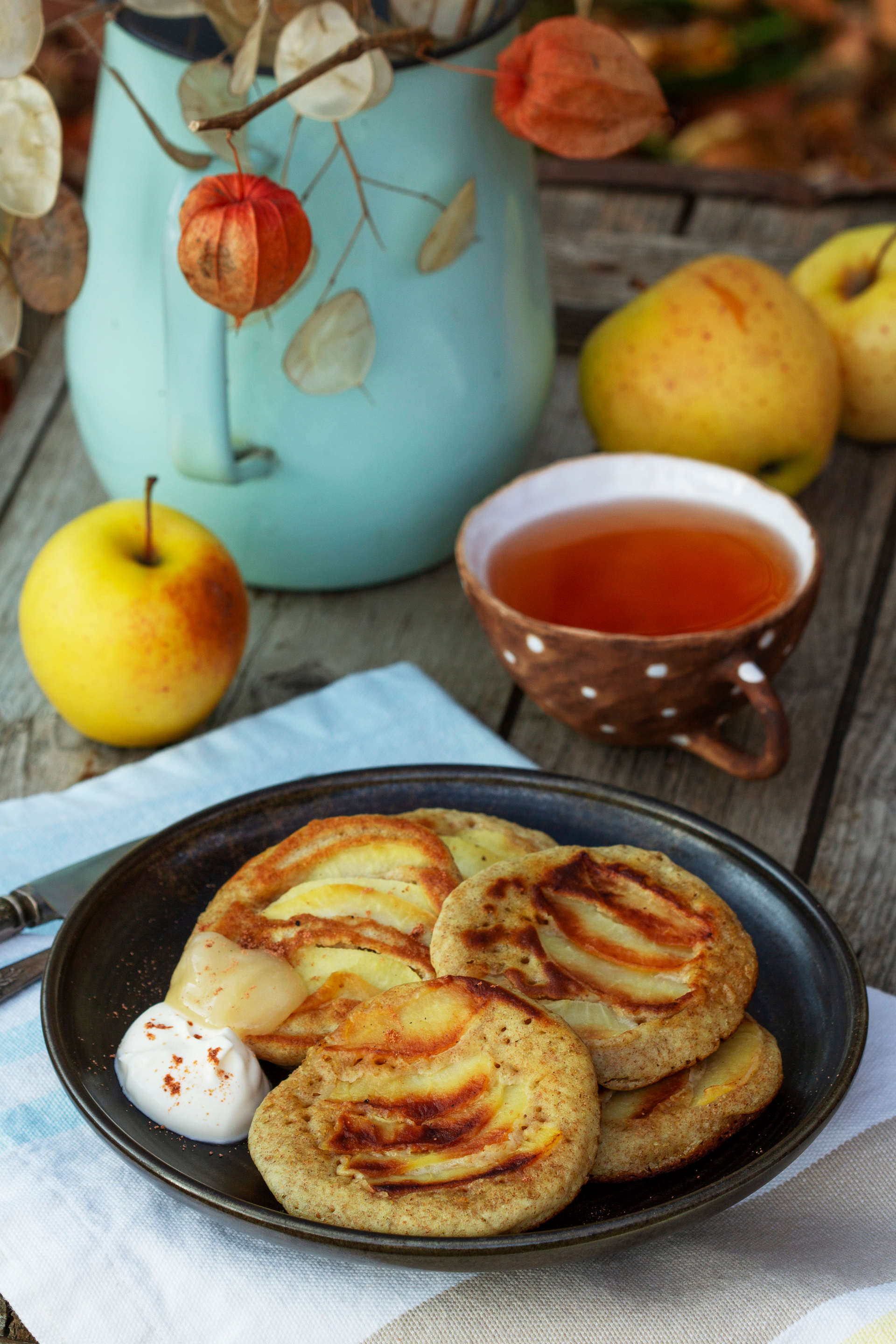 Overhead flat-lay of all ingredients for Creamy Dutch Apple Pancakes with Maple Glaze laid out on a kitchen surface.