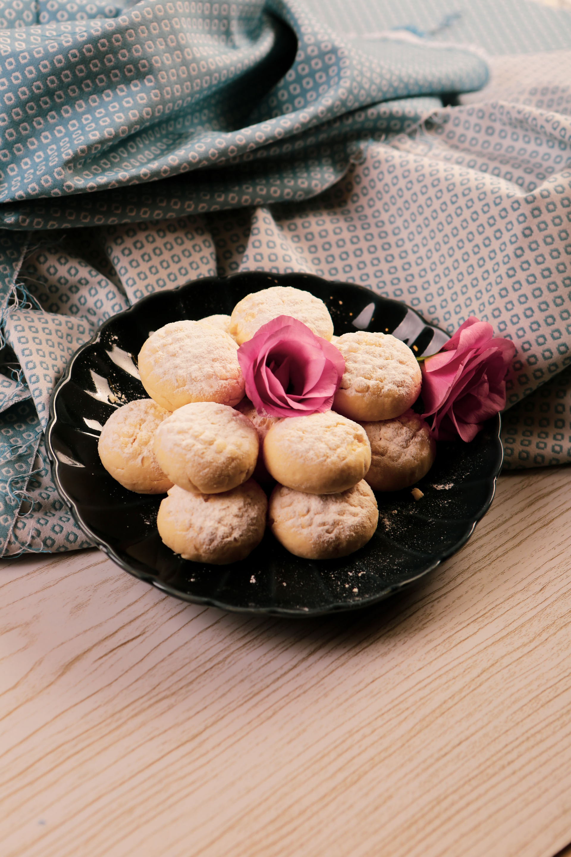 Overhead flat-lay of all ingredients for Creamy Egyptian Kahk Cookies with Rosewater Essence laid out on a kitchen surface.