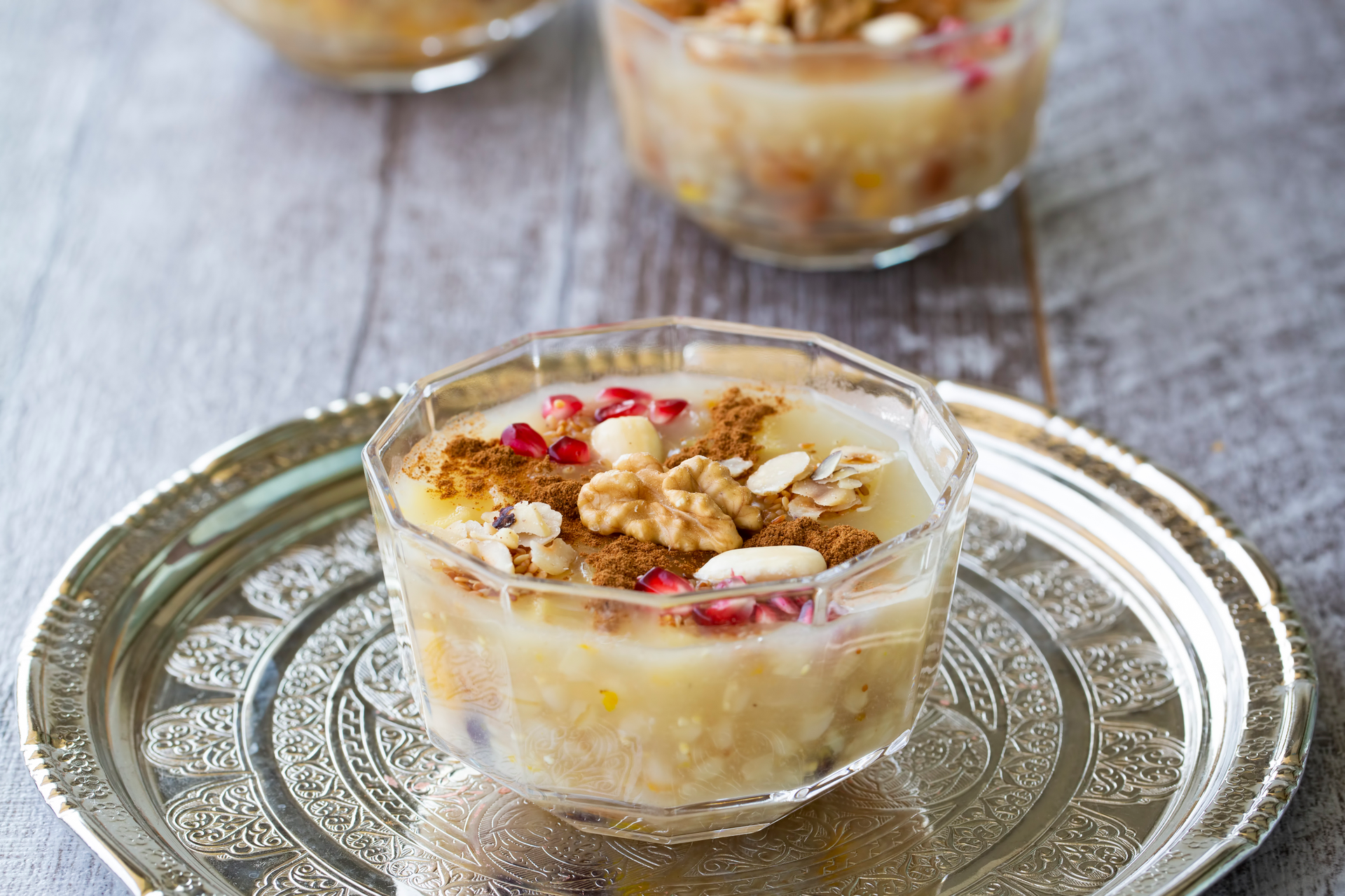 Overhead flat-lay of all ingredients for Creamy Egyptian Om Ali Pudding with Cardamom and Almonds laid out on a kitchen surface.