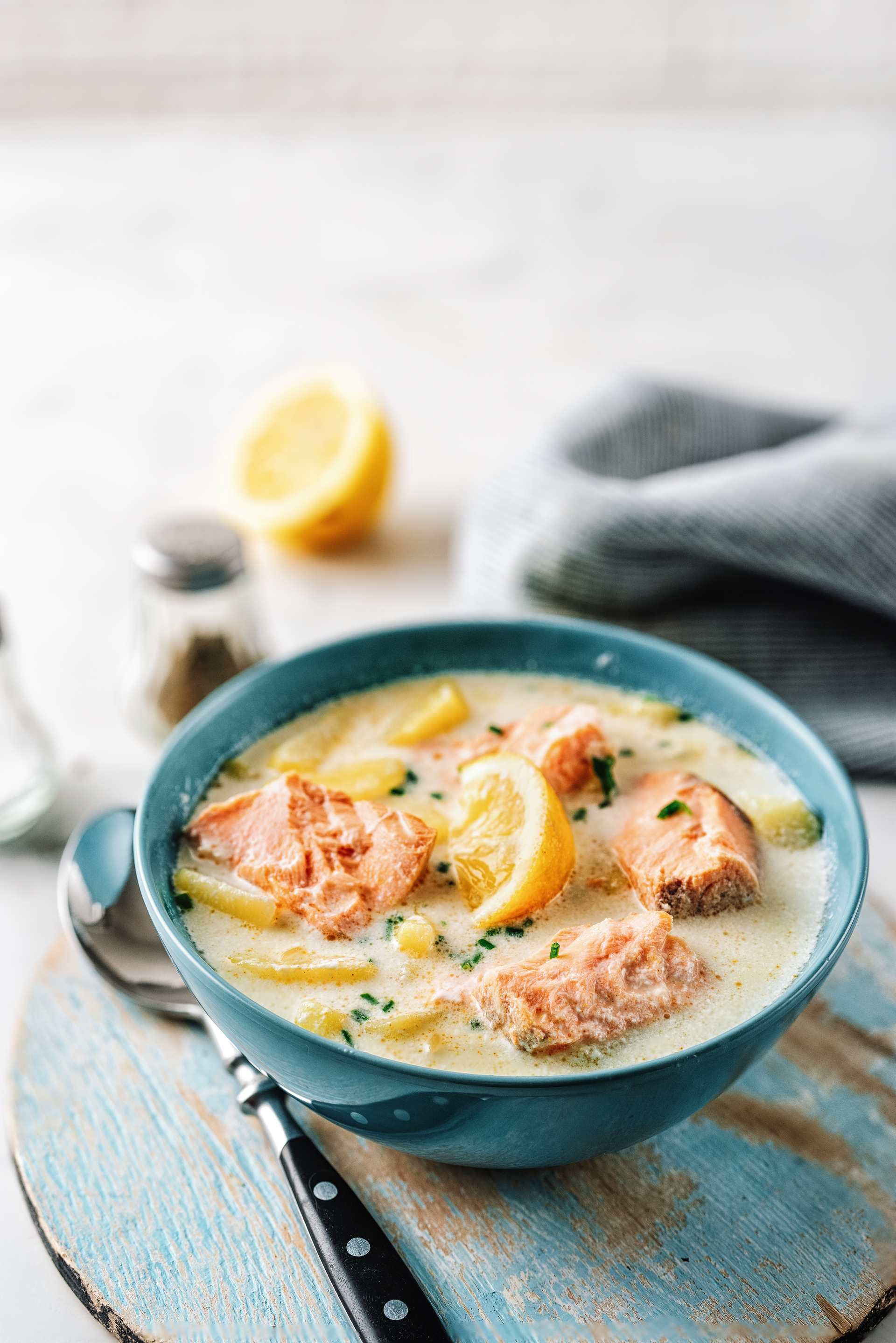 Overhead flat-lay of all ingredients for Creamy Finnish Salmon Soup laid out on a kitchen surface.