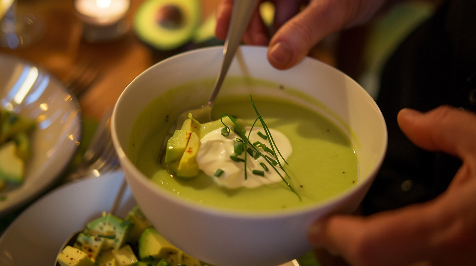 Overhead flat-lay of all ingredients for Creamy Guatemalan Avocado Soup with Cilantro Cream laid out on a kitchen surface.