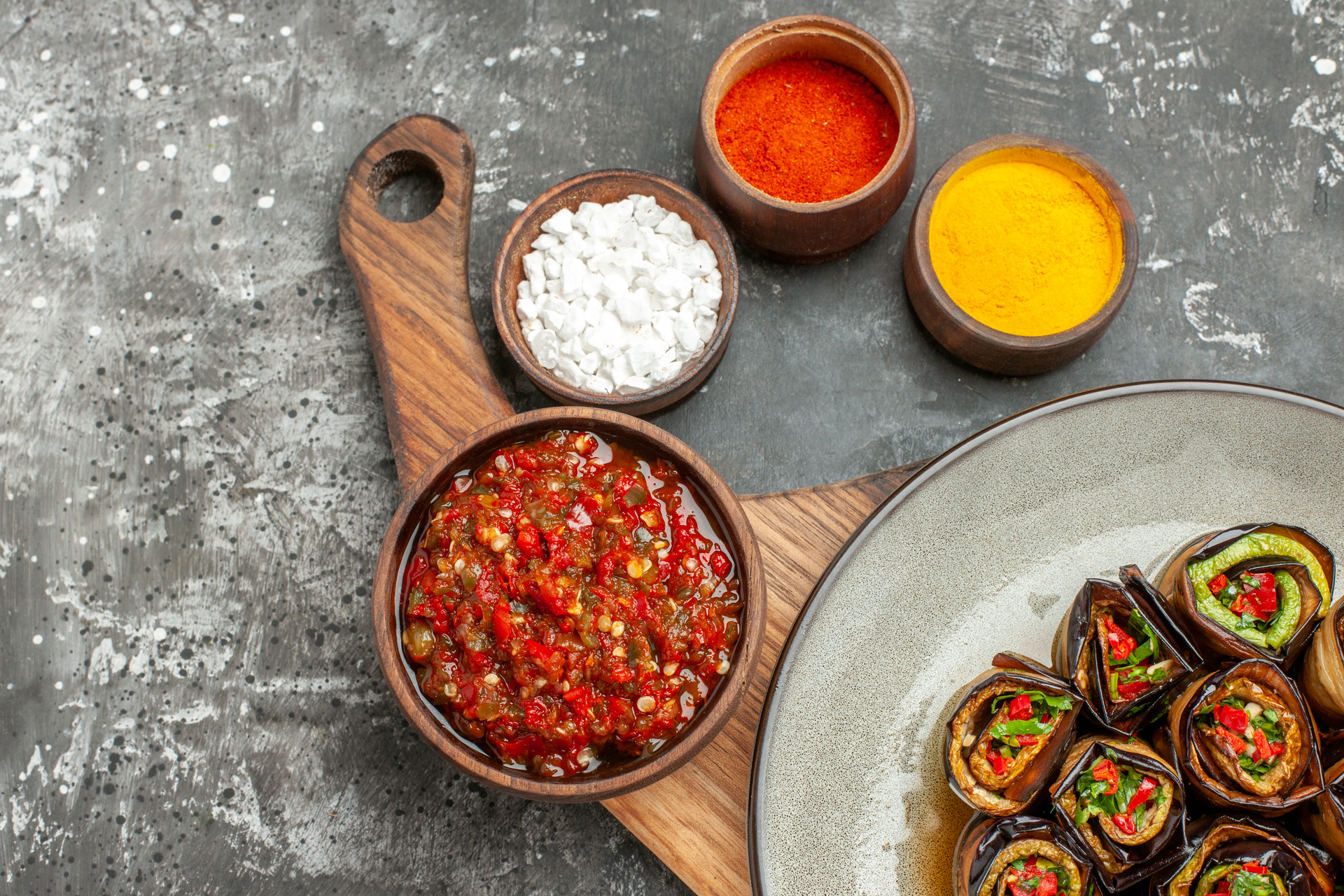 Overhead flat-lay of all ingredients for Creamy Guatemalan Pepián Rojo with Tomato-Cinnamon Sauce laid out on a kitchen surface.