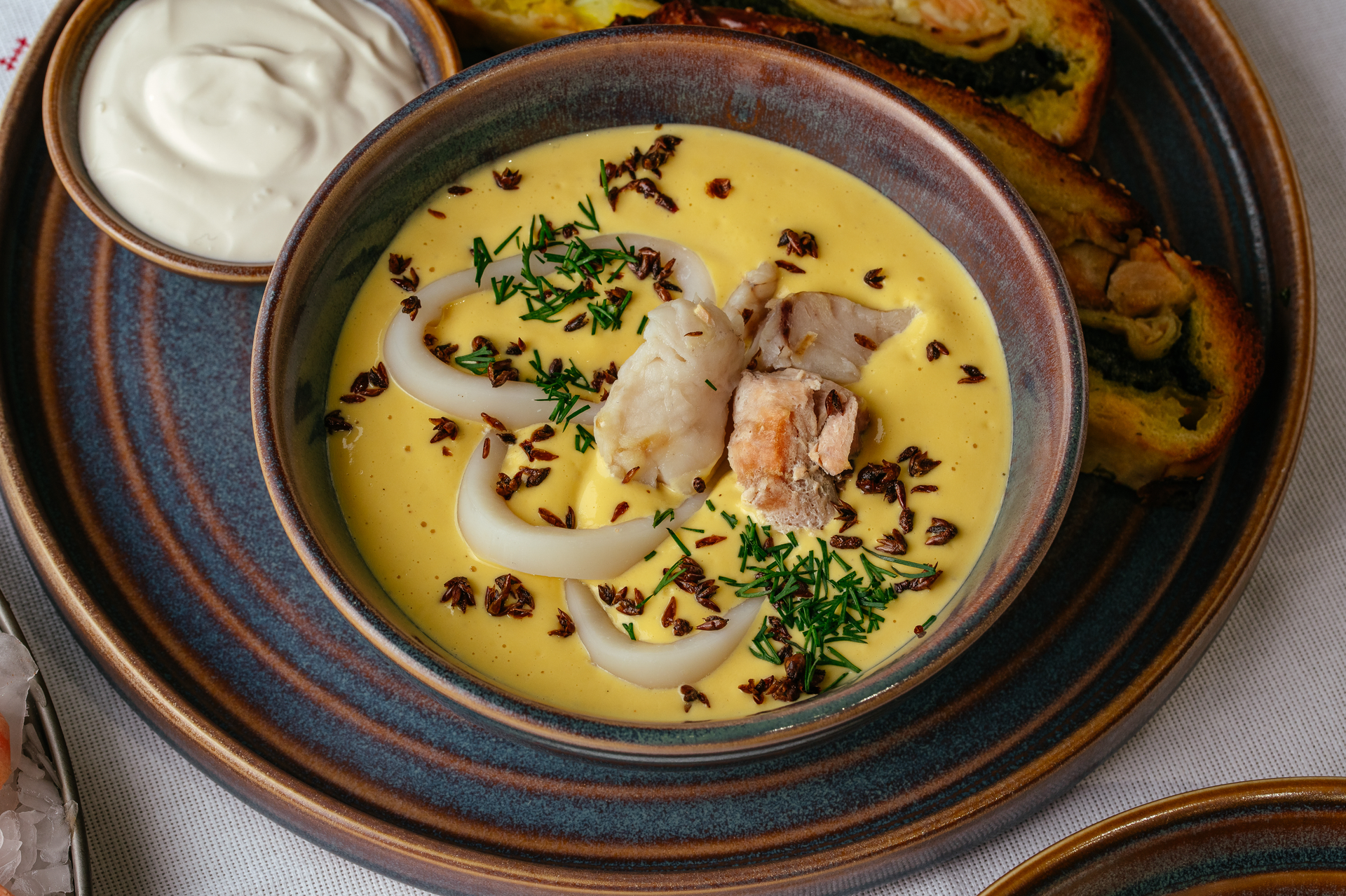 Overhead flat-lay of all ingredients for Creamy Icelandic Fish Chowder with Dill and Saffron laid out on a kitchen surface.
