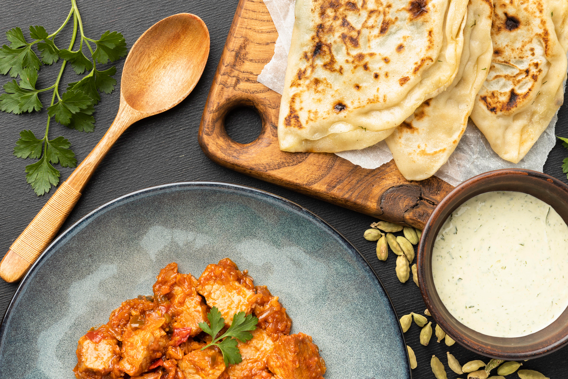 Creamy Indian Butter Chicken with Garlic Naan — Main Course served and photographed from above