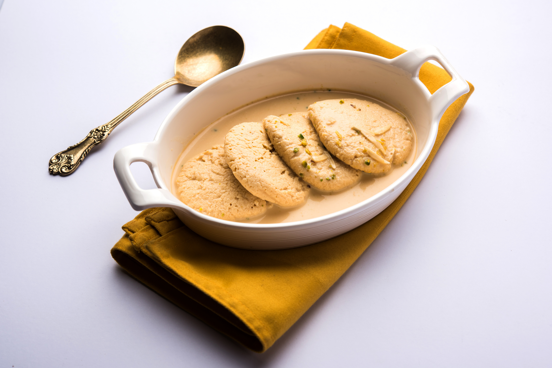 Overhead flat-lay of all ingredients for Creamy Indian Malai Kofta with Cashew Gravy laid out on a kitchen surface.