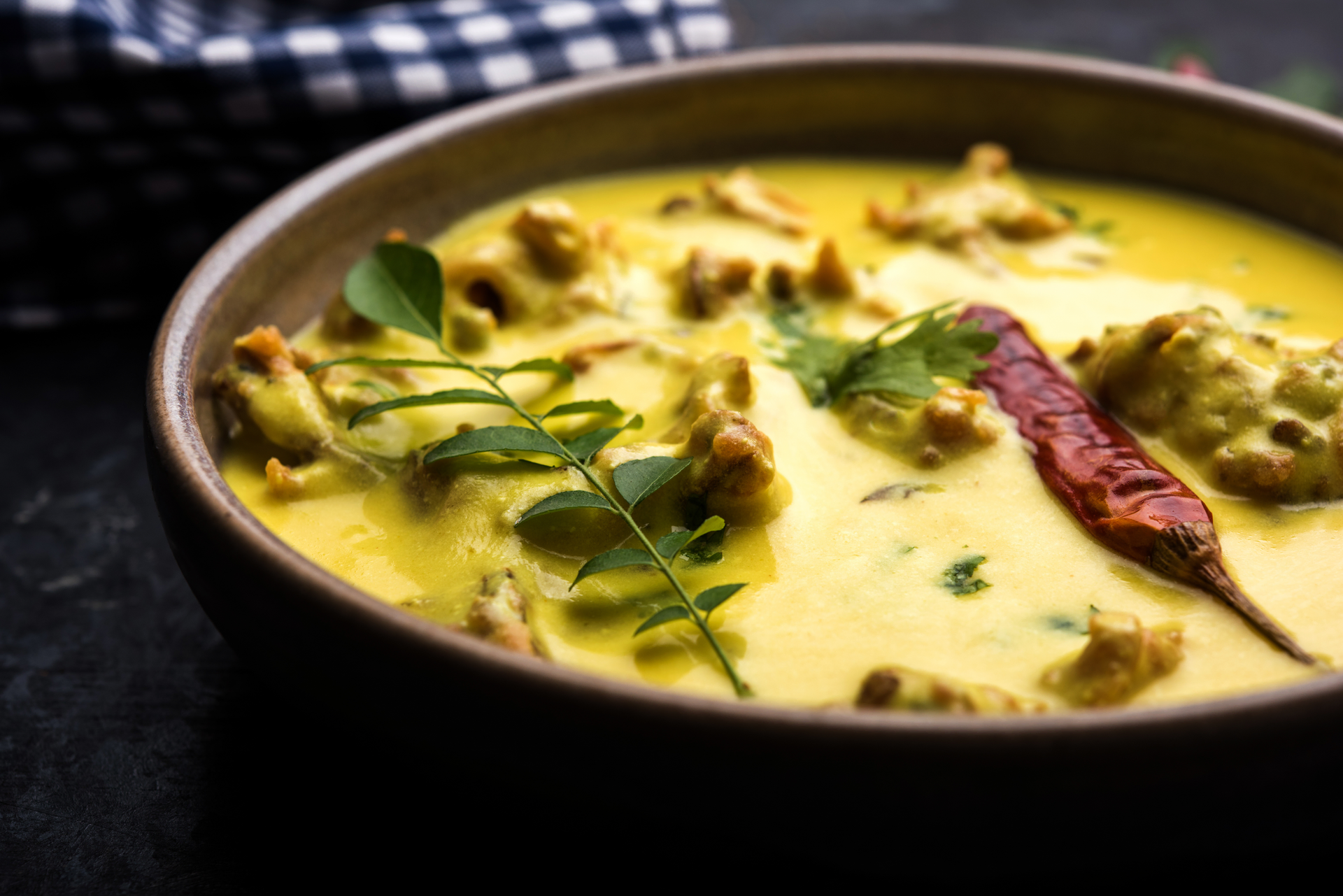 Overhead flat-lay of all ingredients for Creamy Indian Saffron Chicken Korma with Almond Gravy laid out on a kitchen surface.
