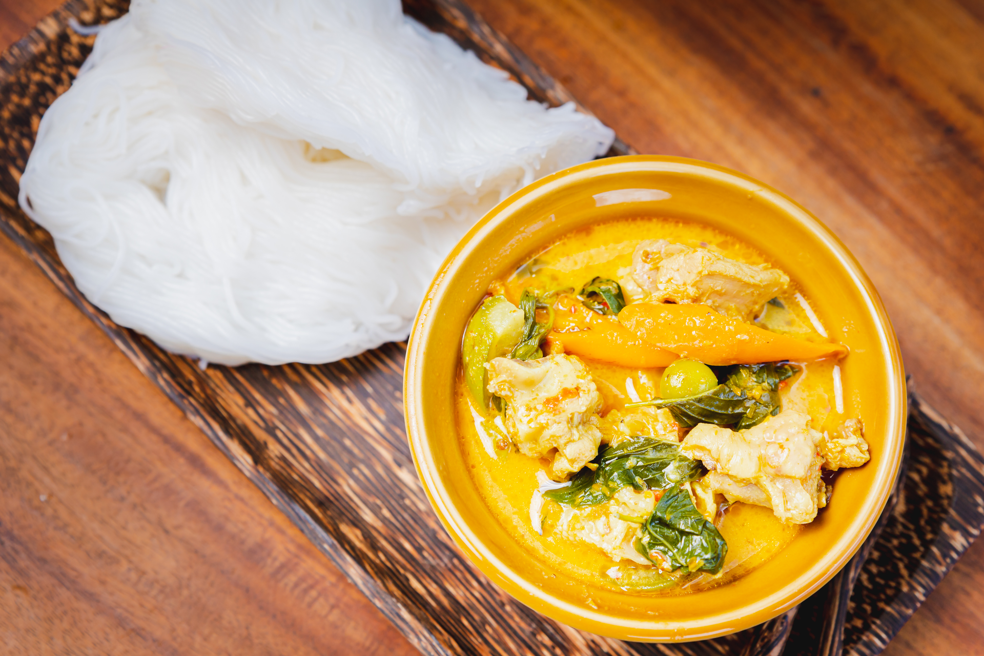 Overhead flat-lay of all ingredients for Creamy Indonesian Lontong Sayur with Coconut Curry laid out on a kitchen surface.