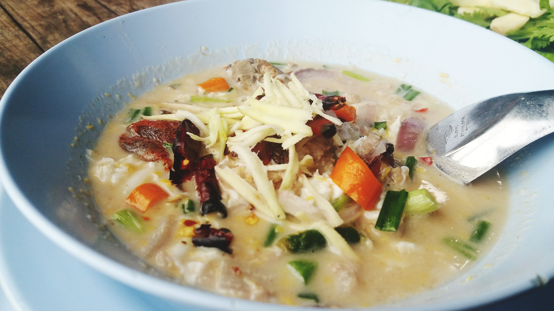 Overhead flat-lay of all ingredients for Creamy Indonesian Soto Betawi laid out on a kitchen surface.