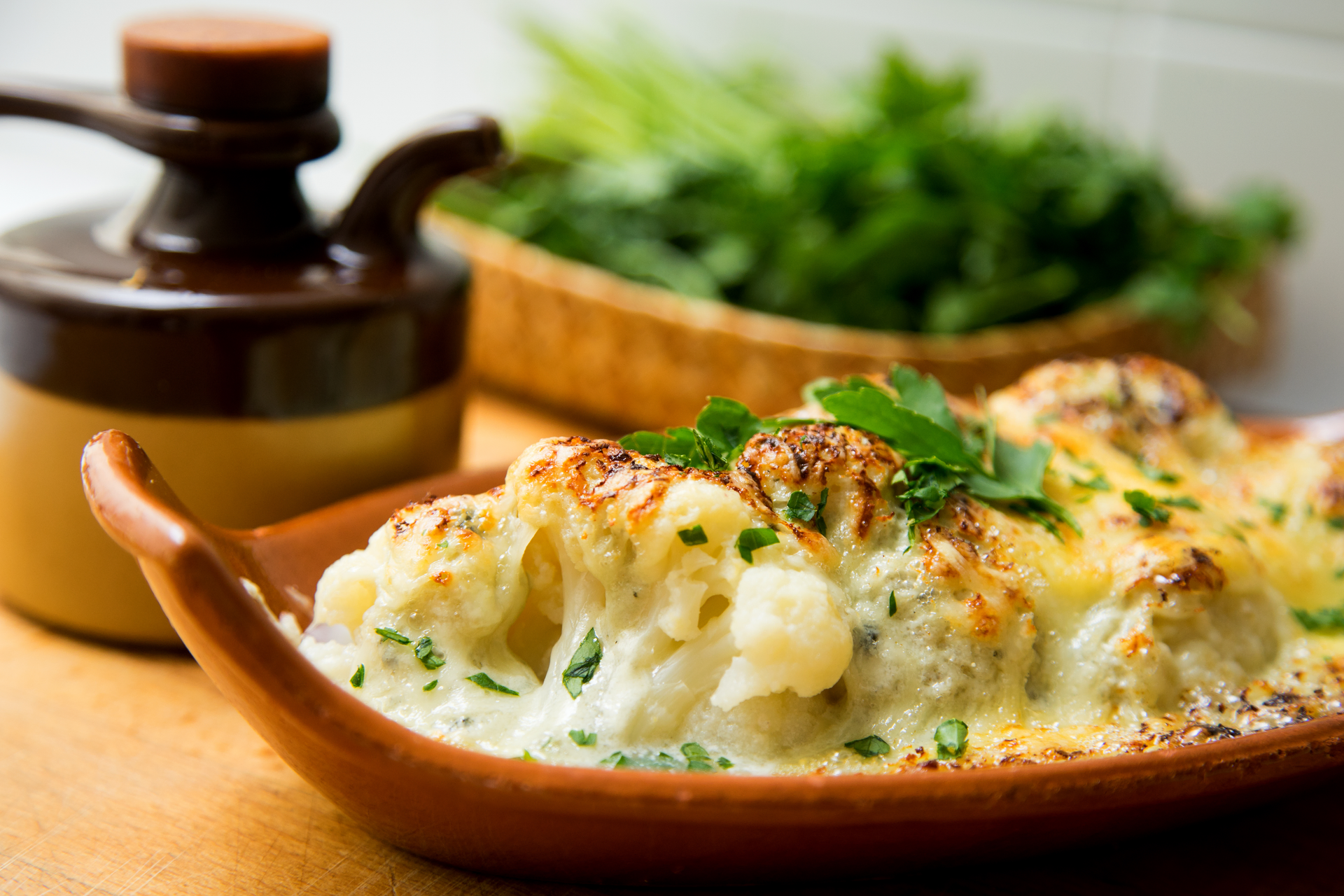 Overhead flat-lay of all ingredients for Creamy Irish Colcannon with Leeks and Butter laid out on a kitchen surface.