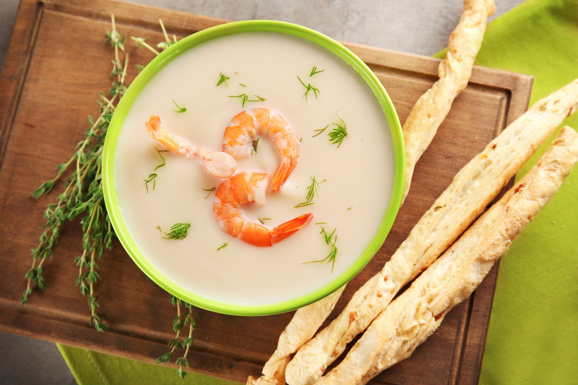 Overhead flat-lay of all ingredients for Creamy Island-Style Shrimp Chowder with Coconut and Lime laid out on a kitchen surface.