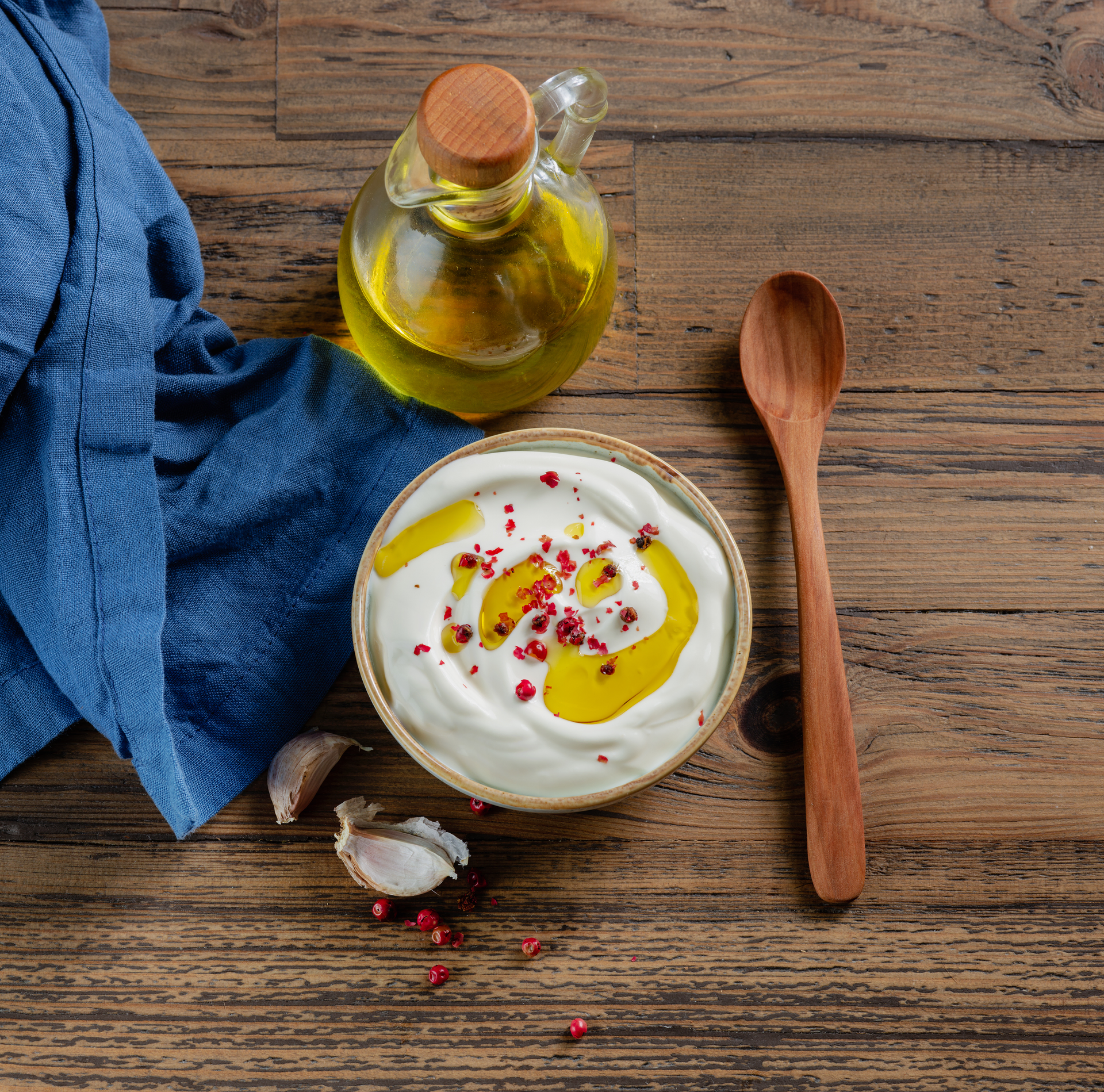 Overhead flat-lay of all ingredients for Creamy Israeli Labneh with Za'atar Oil Drizzle laid out on a kitchen surface.