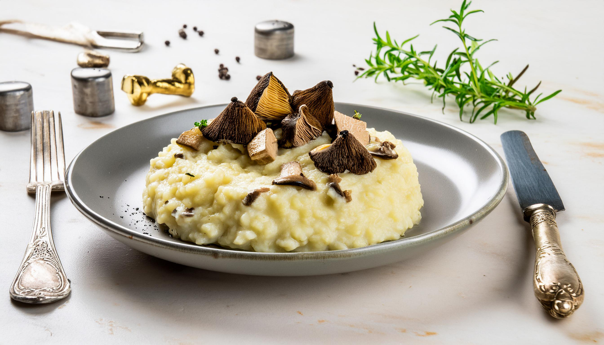 Overhead flat-lay of all ingredients for Creamy Italian Risotto with Black Truffle and Parmesan laid out on a kitchen surface.