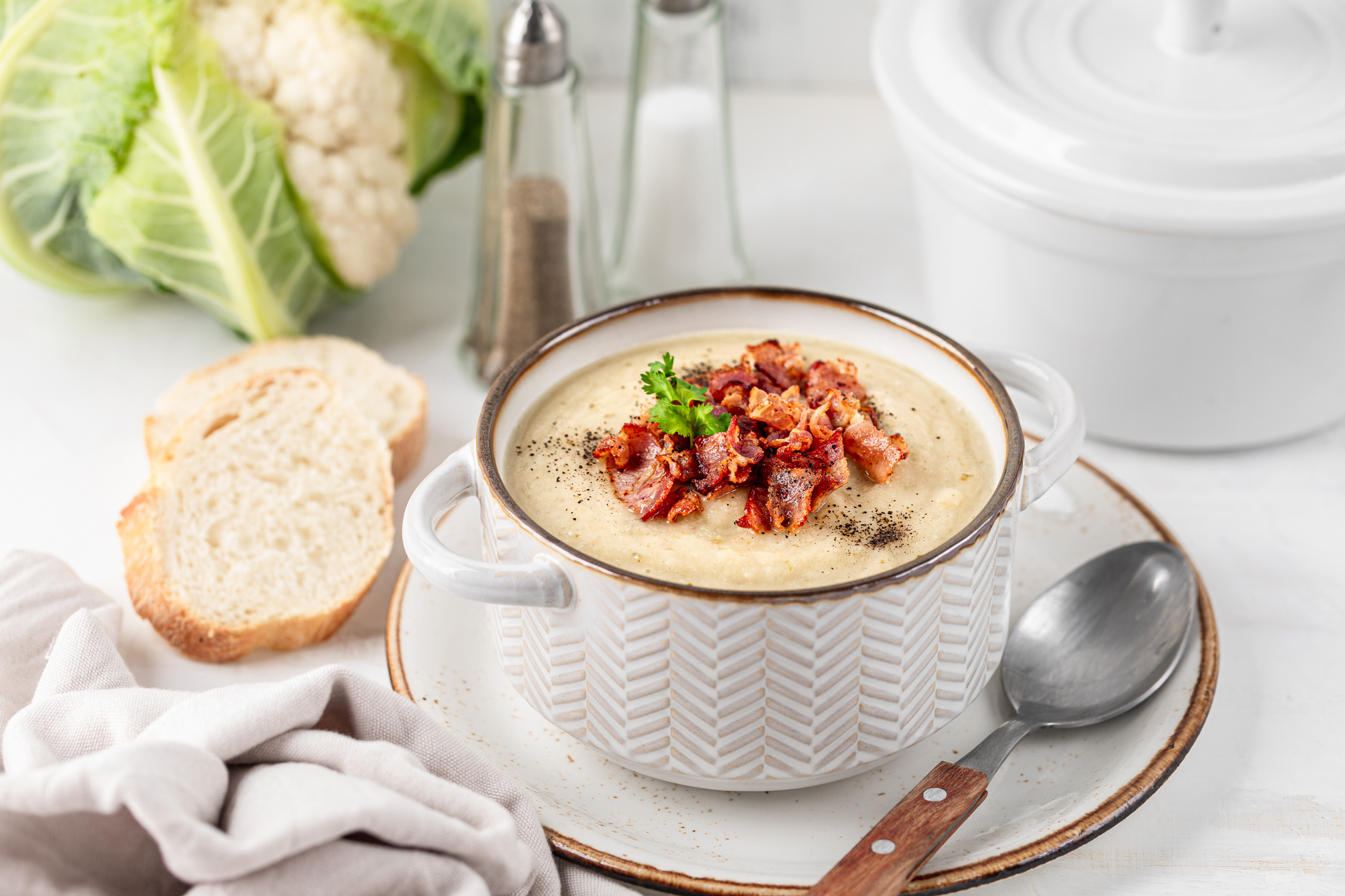 Overhead flat-lay of all ingredients for Creamy Luxembourgish Bouneschlupp laid out on a kitchen surface.