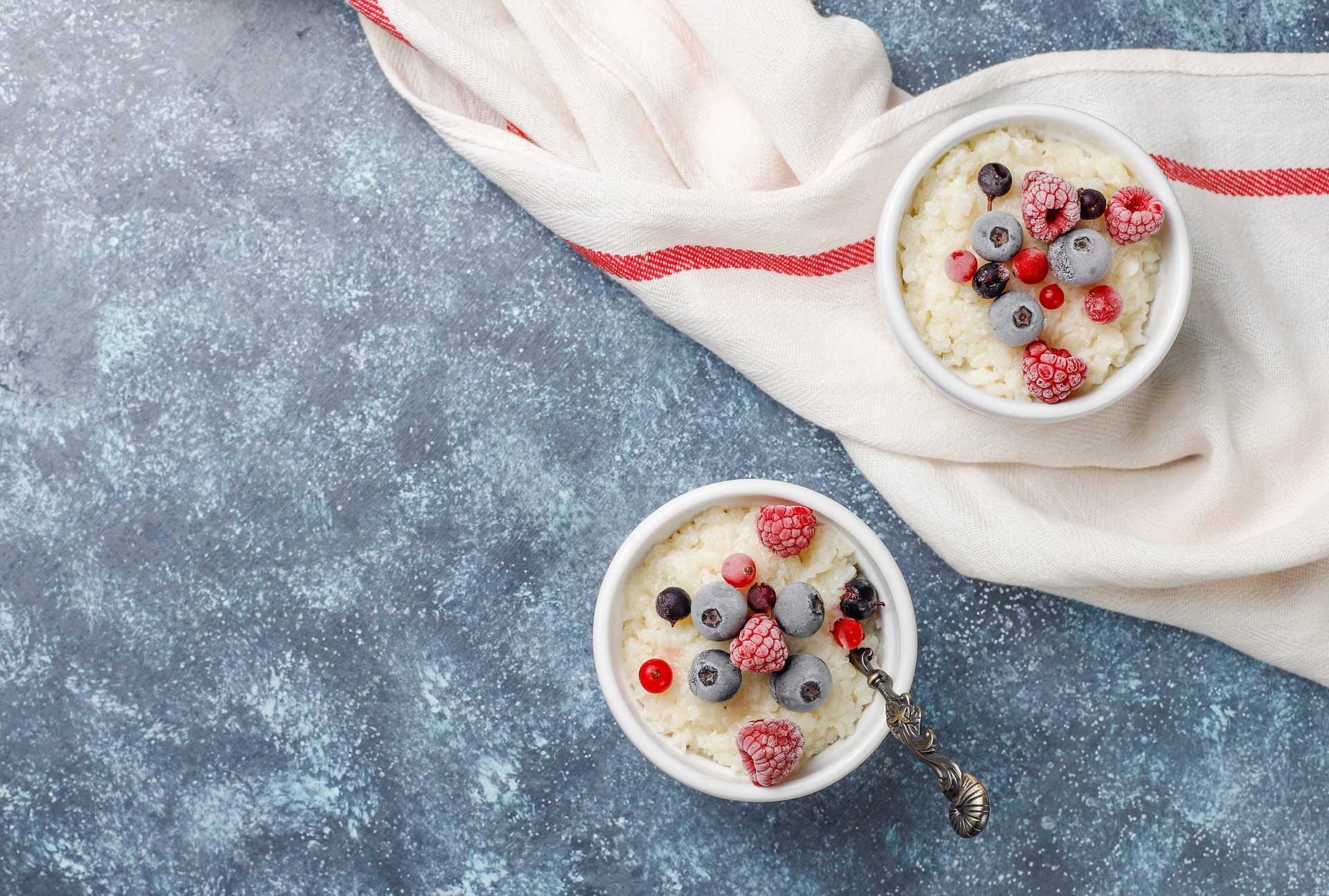 Creamy Madagascar Vanilla Bean Rice Pudding with Fresh Berries — Dessert served and photographed from above
