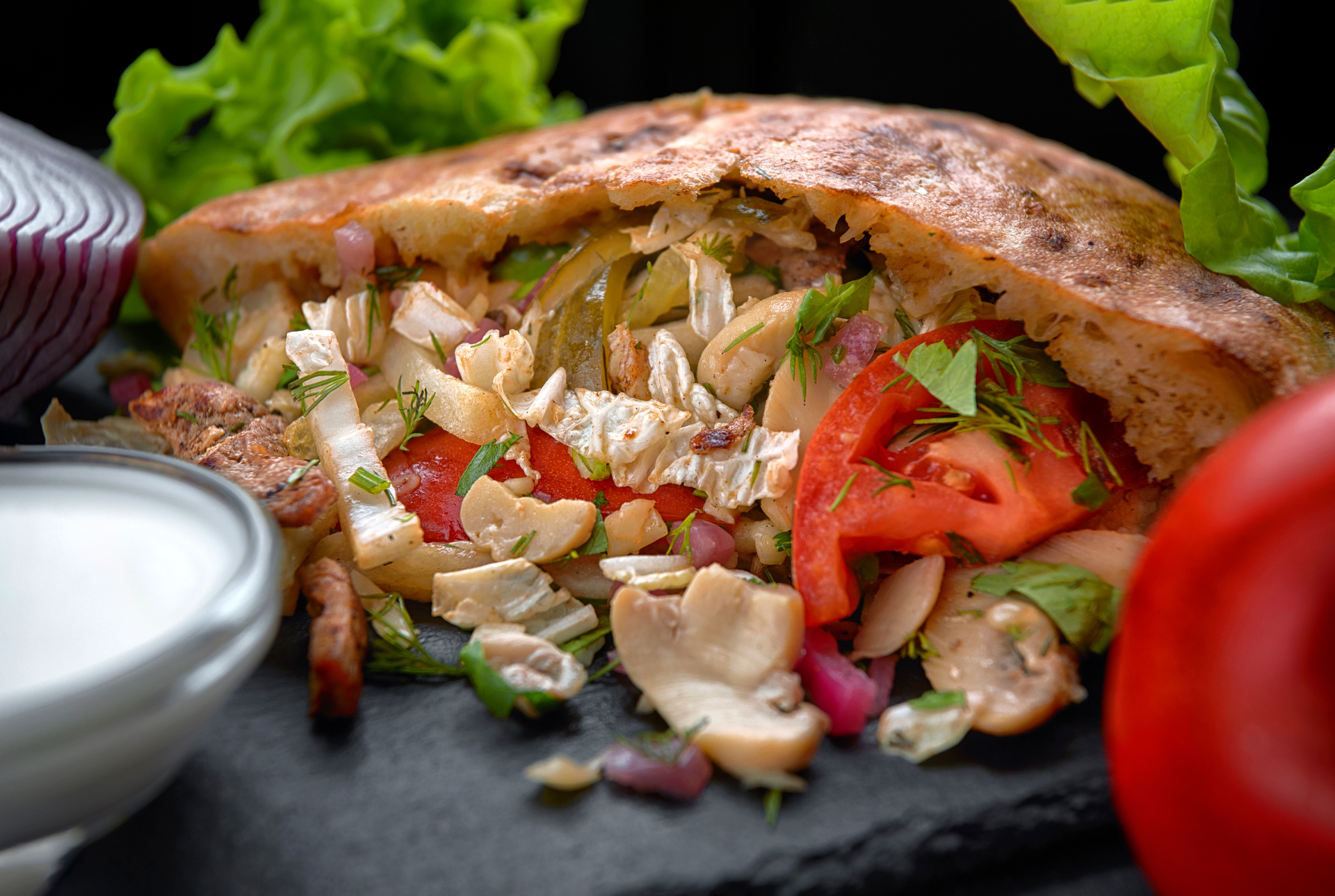 Overhead flat-lay of all ingredients for Creamy Mediterranean Chicken Shawarma laid out on a kitchen surface.