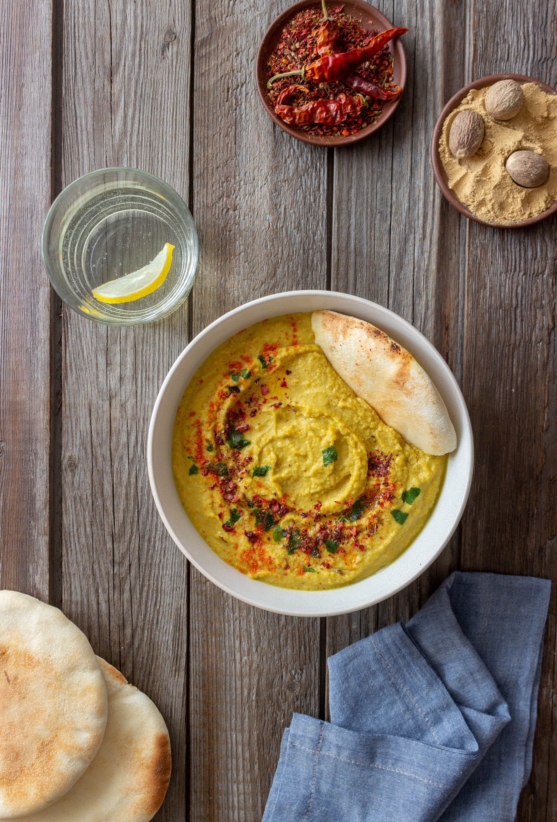 Overhead flat-lay of all ingredients for Creamy Moroccan Harira with Seven Spices laid out on a kitchen surface.