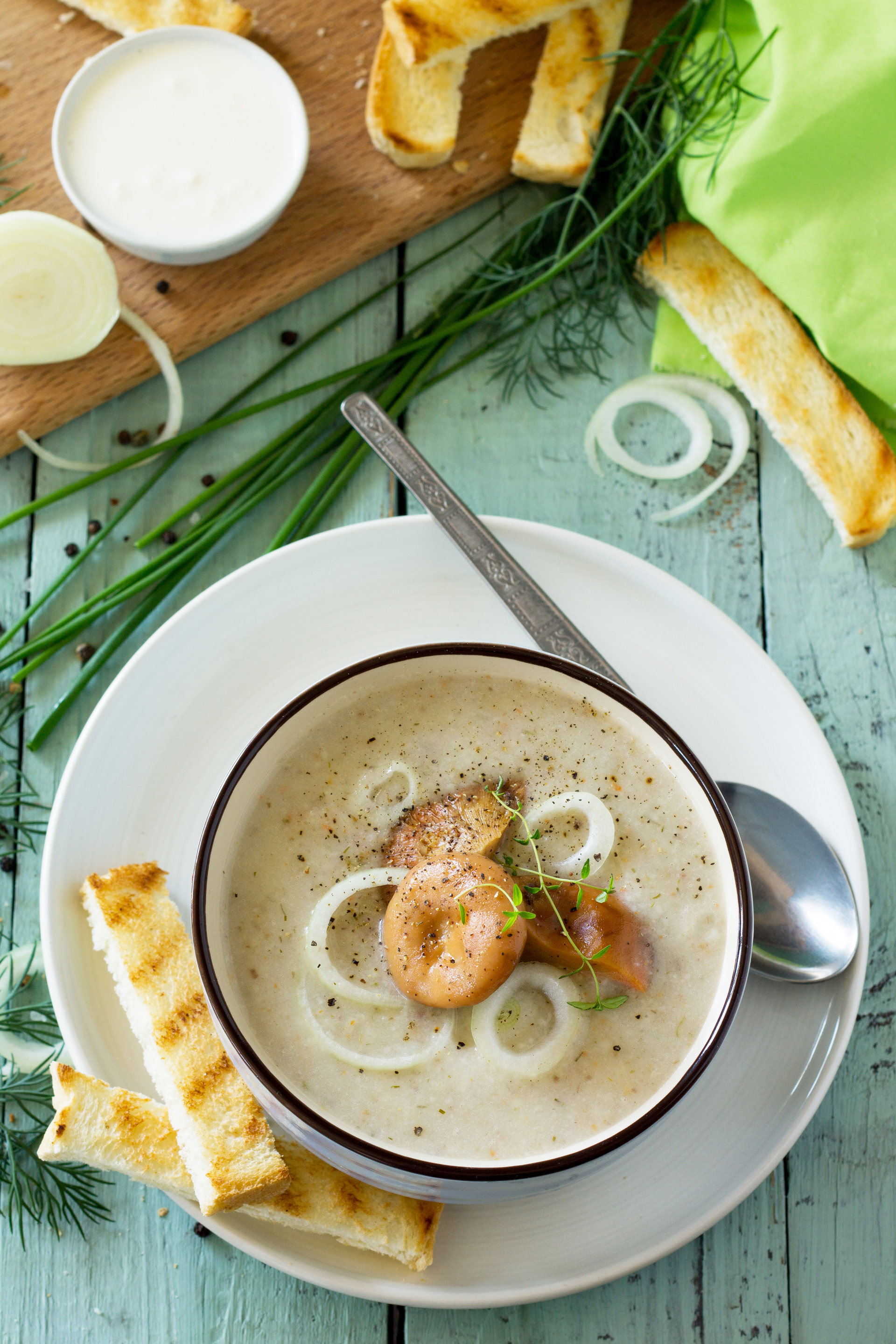 Overhead flat-lay of all ingredients for Creamy Norwegian Fish Soup with Dill and Potatoes laid out on a kitchen surface.
