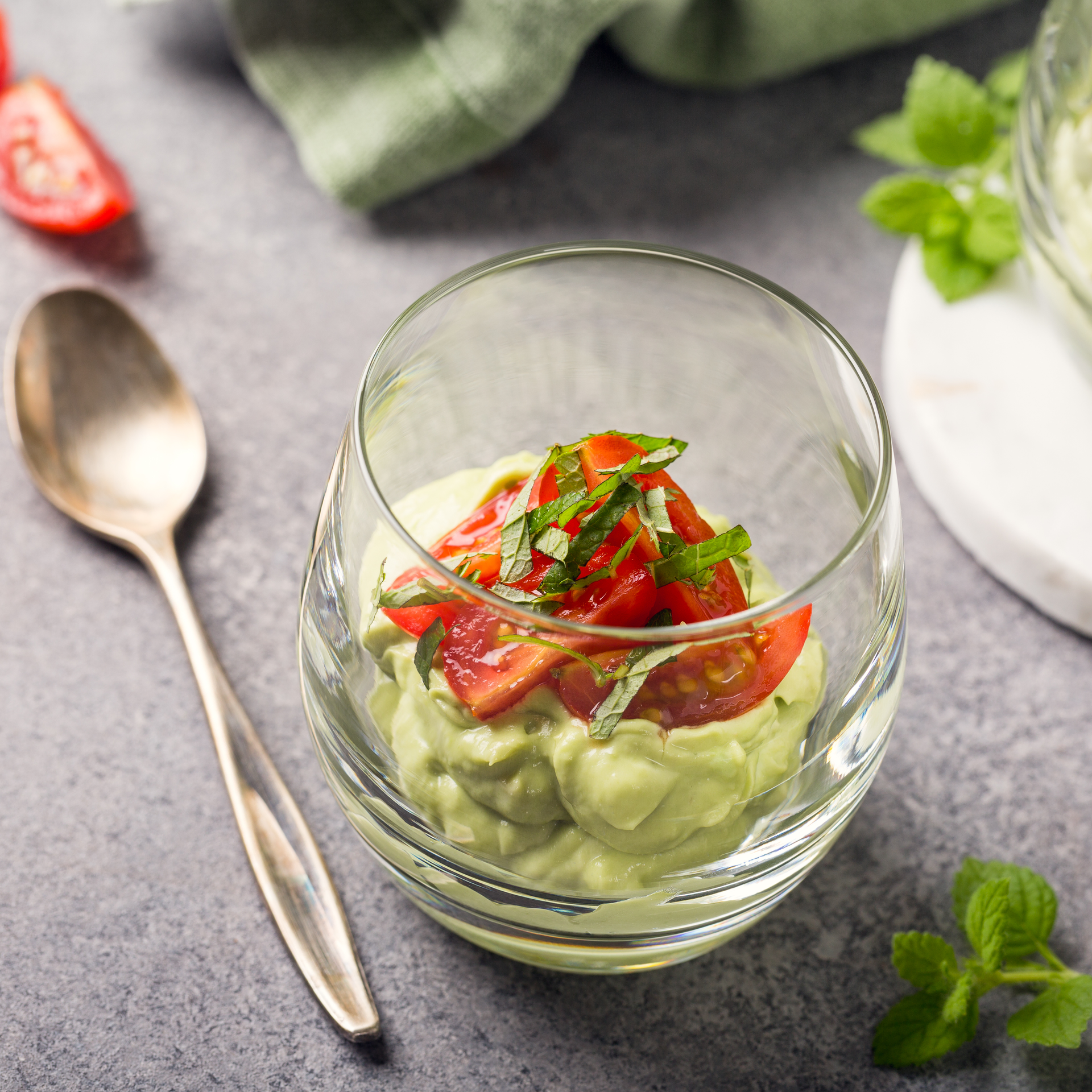 Overhead flat-lay of all ingredients for Creamy Peruvian Avocado Mousse with Lime and Chili laid out on a kitchen surface.