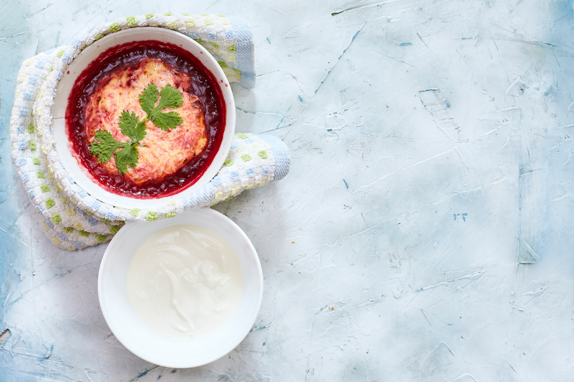 Overhead flat-lay of all ingredients for Creamy Polish Barszcz Biały laid out on a kitchen surface.
