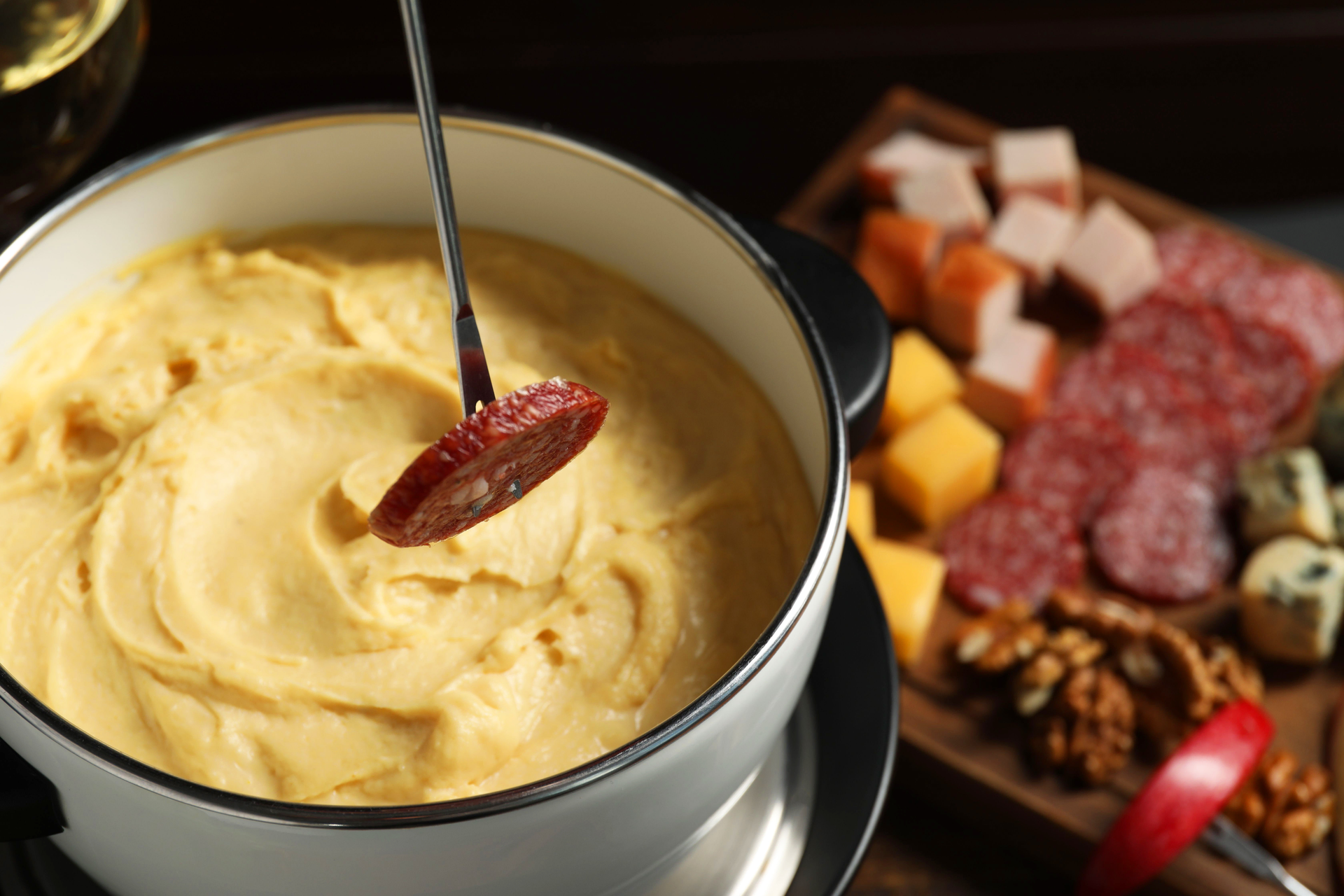 Overhead flat-lay of all ingredients for Creamy Swiss Fondue laid out on a kitchen surface.