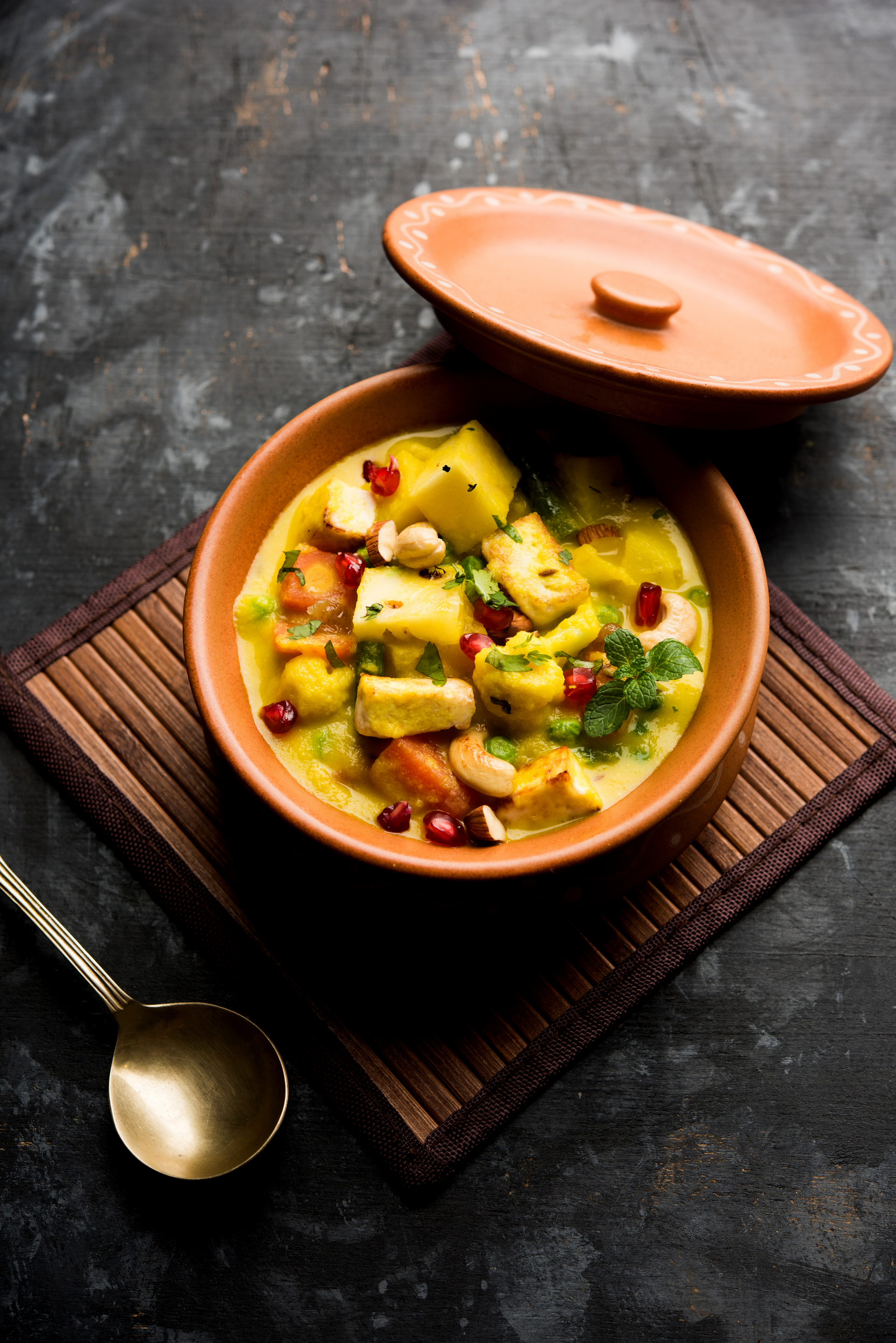 Overhead flat-lay of all ingredients for Creamy Tanzanian Coconut Bean Stew with Plantains laid out on a kitchen surface.