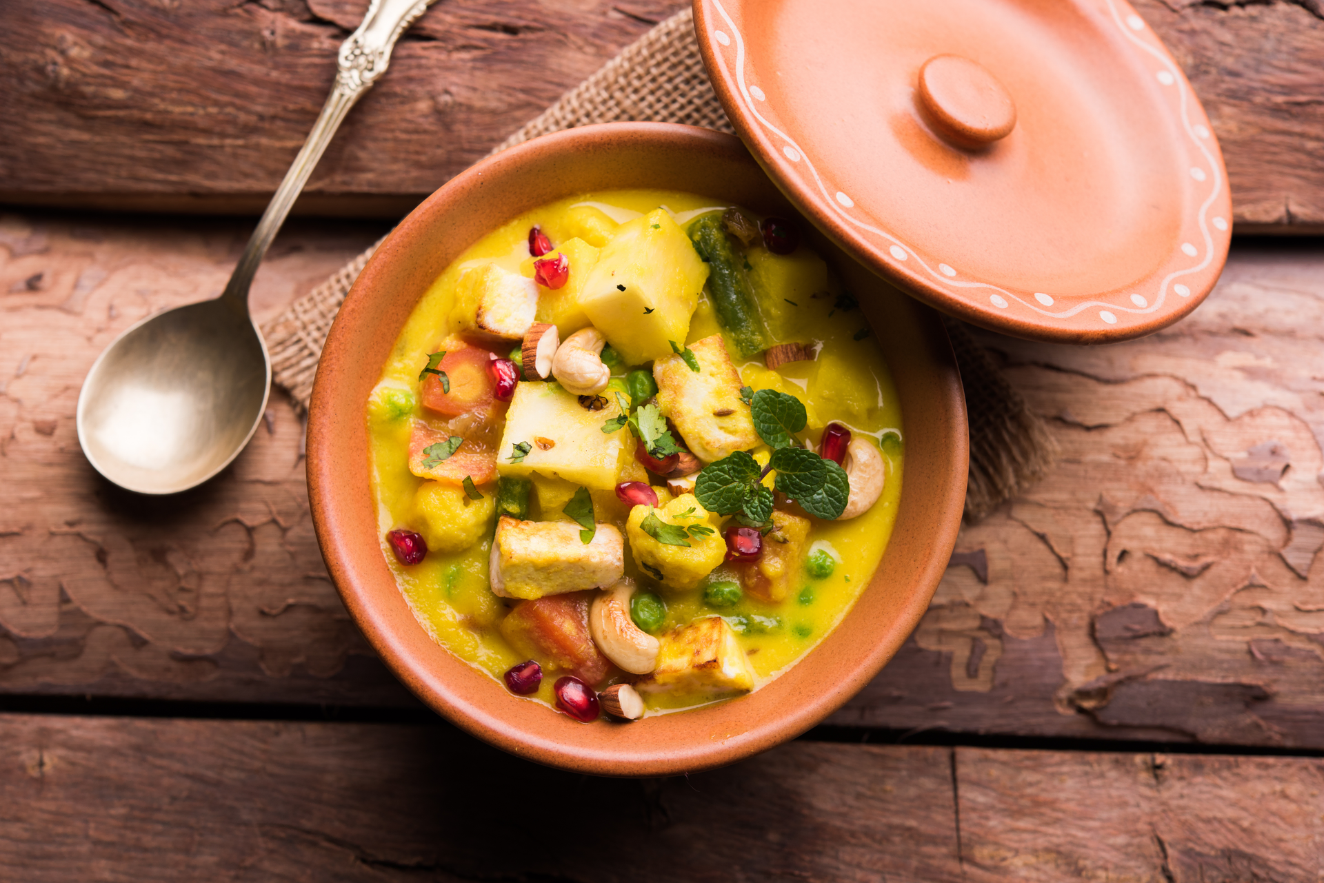Overhead flat-lay of all ingredients for Creamy Tanzanian Coconut Fish Curry with Plantains laid out on a kitchen surface.