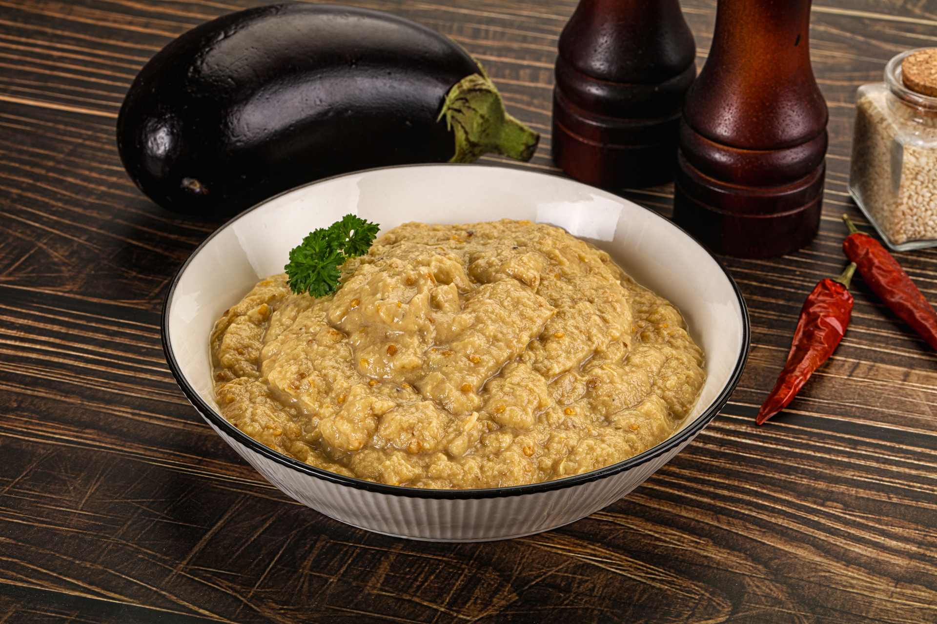 Overhead flat-lay of all ingredients for Creamy Turkish Hünkâr Beğendi with Smoked Aubergine Puree laid out on a kitchen surface.
