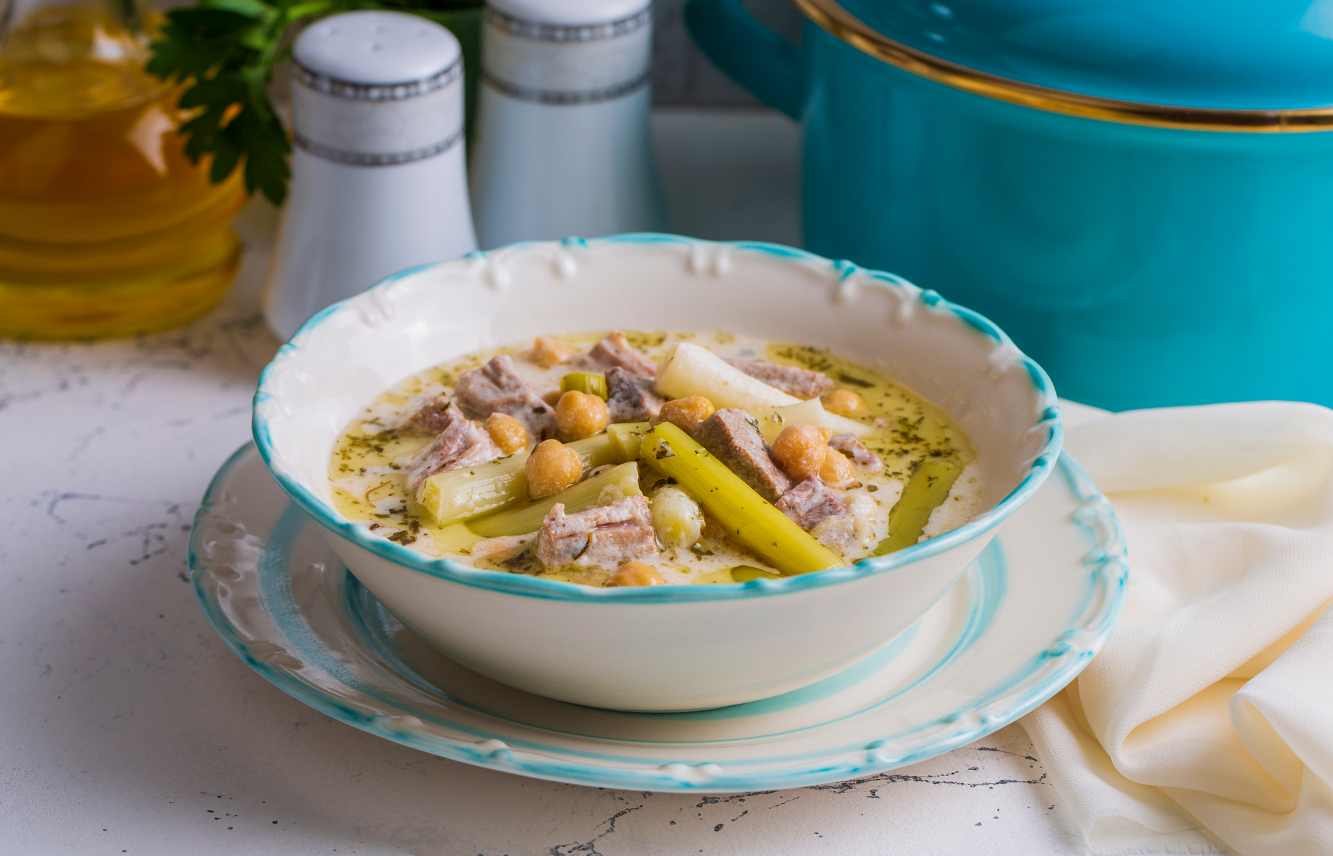 Overhead flat-lay of all ingredients for Creamy Welsh Cawl with Leeks and Sea Salt Butter laid out on a kitchen surface.