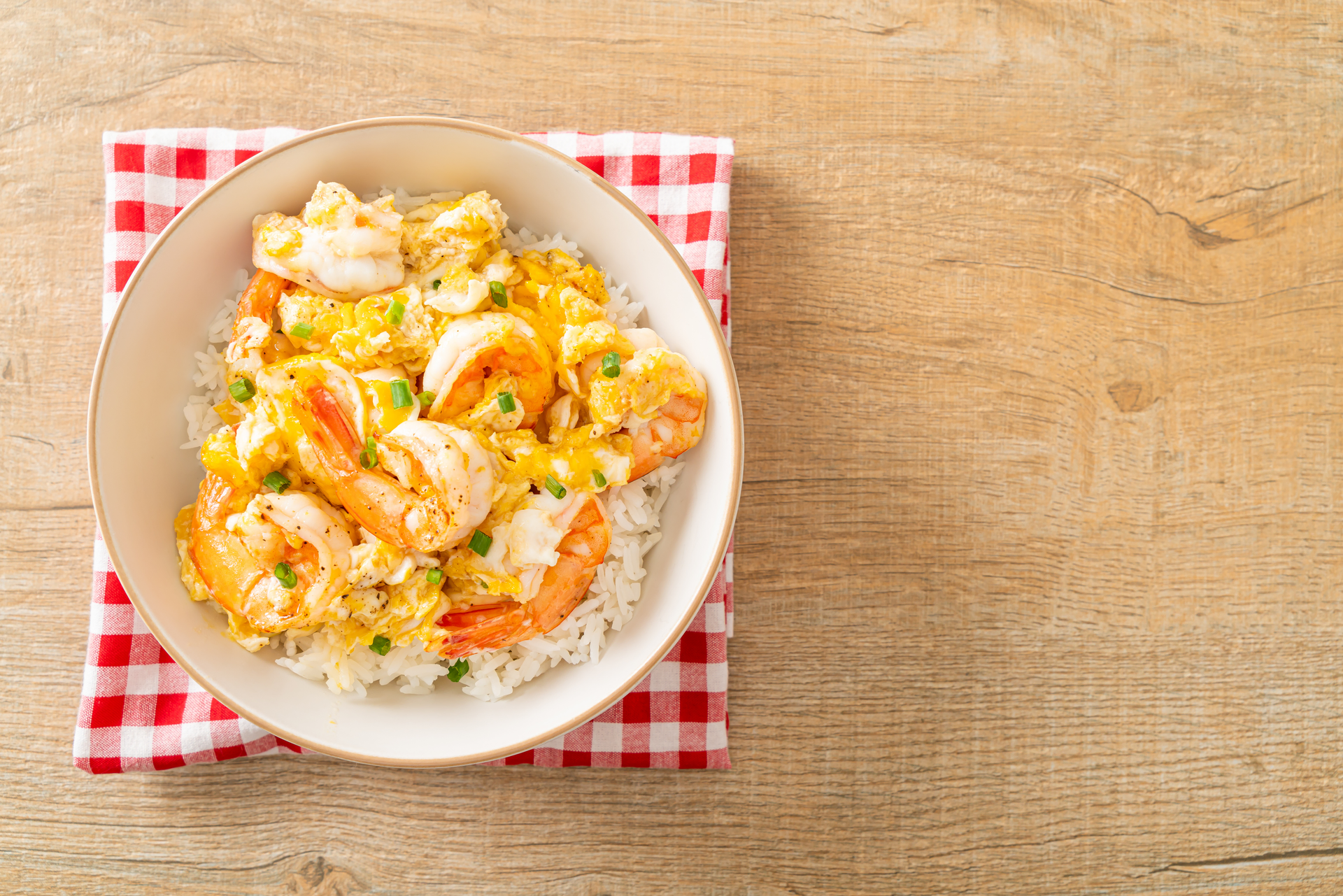 Overhead flat-lay of all ingredients for Creole Shrimp Étouffée with Rice and Celery laid out on a kitchen surface.