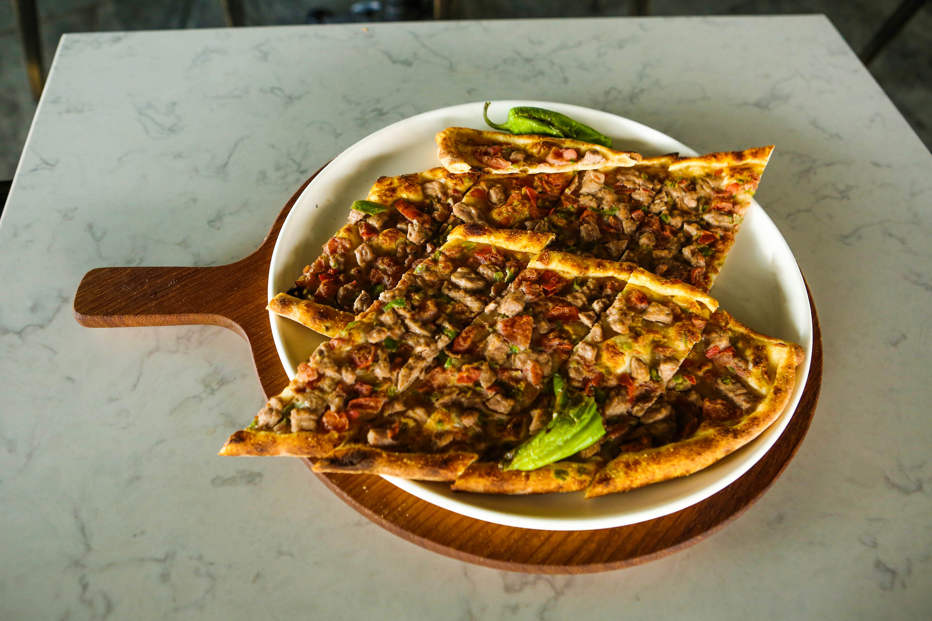 Overhead flat-lay of all ingredients for Crispy Egyptian Hawawshi Bites with Spicy Minced Beef laid out on a kitchen surface.