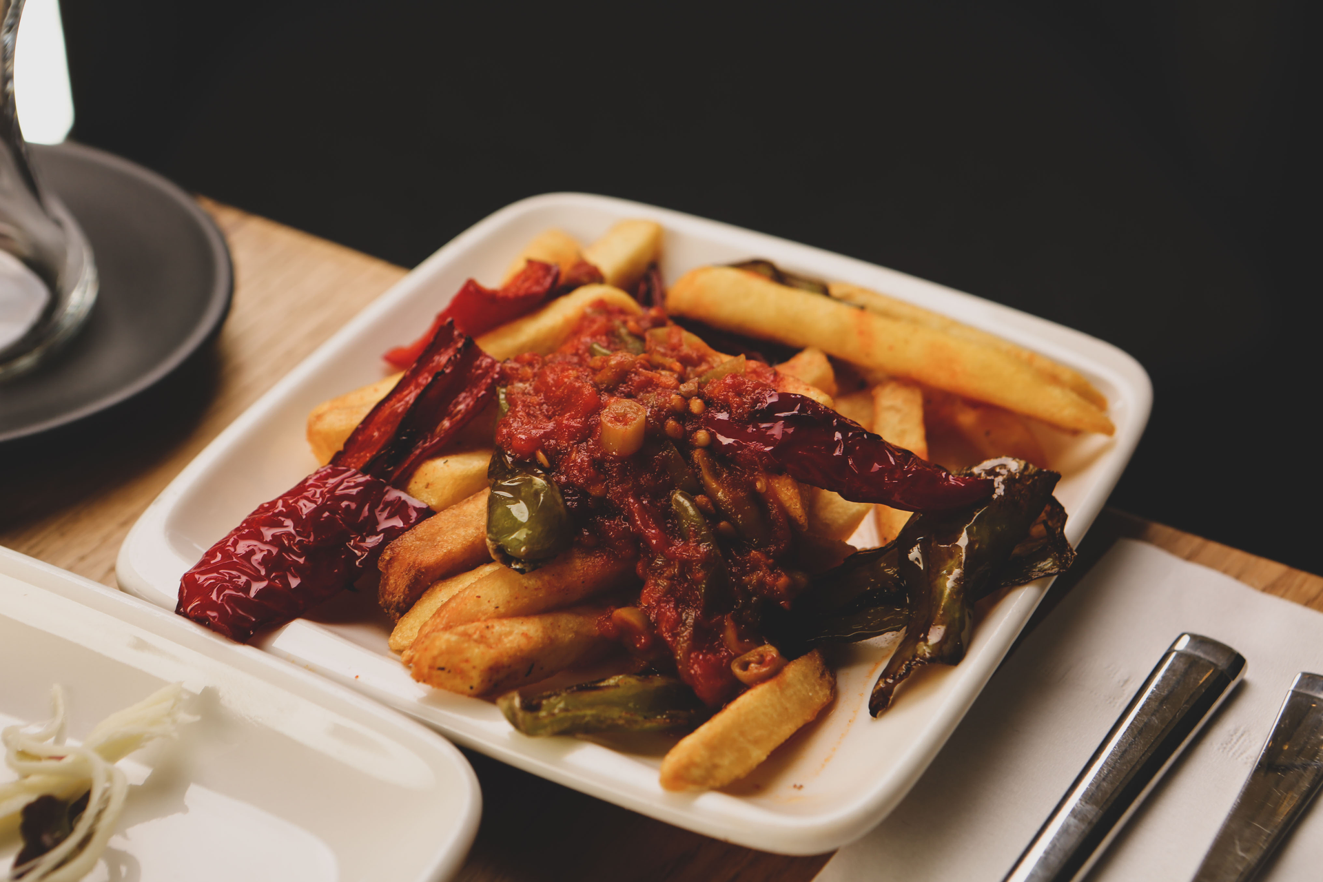 Overhead flat-lay of all ingredients for Crispy Korean Galbi Fries with Kimchi and Cheese laid out on a kitchen surface.