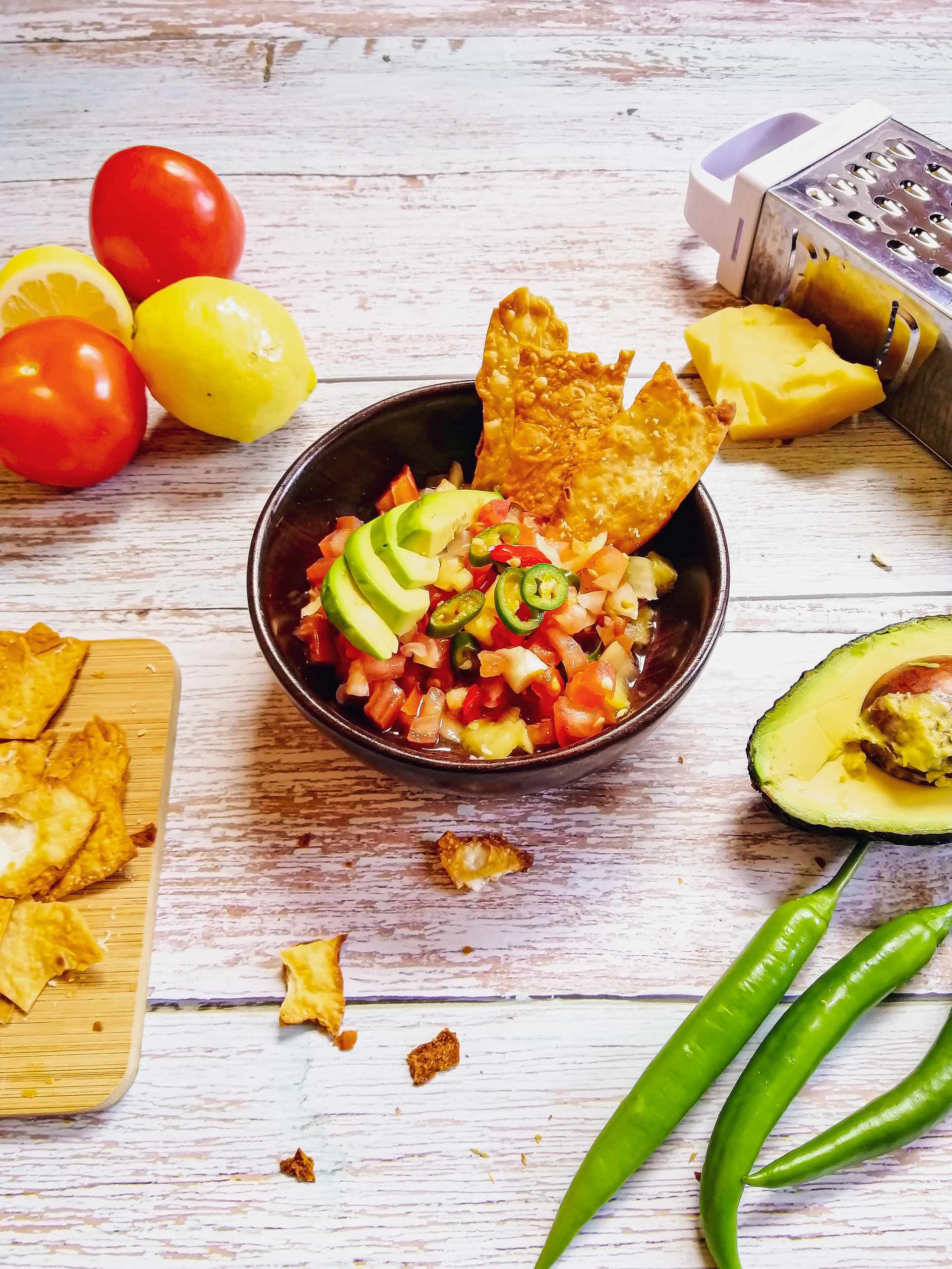 Overhead flat-lay of all ingredients for Crispy Mexican Tostones with Avocado Pico de Gallo laid out on a kitchen surface.