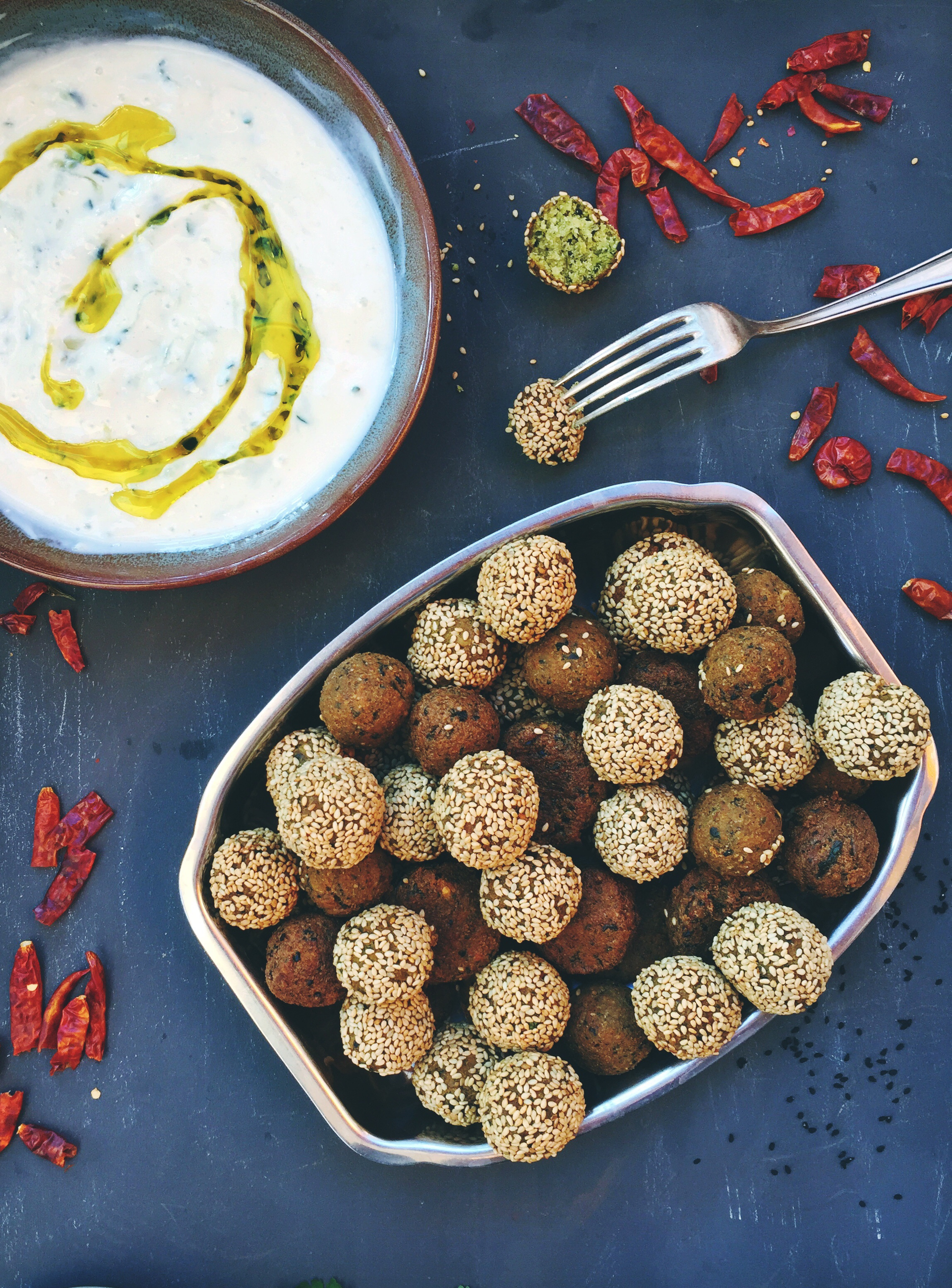 Overhead flat-lay of all ingredients for Crispy Palestinian Falafel Bites with Orange Blossom Tahini laid out on a kitchen surface.
