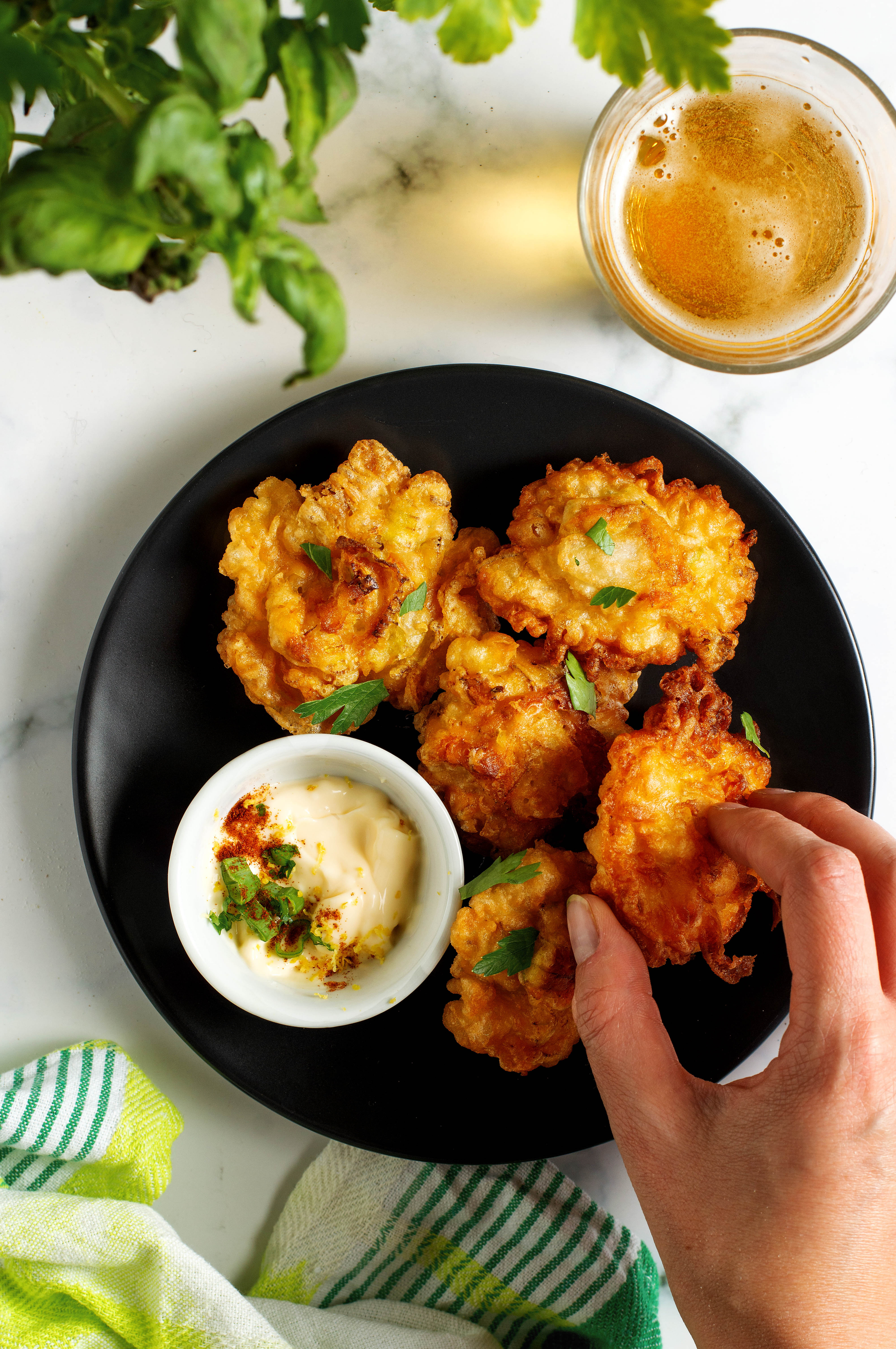 Overhead flat-lay of all ingredients for Crispy Peruvian Yuca Fritters with Aji Verde laid out on a kitchen surface.