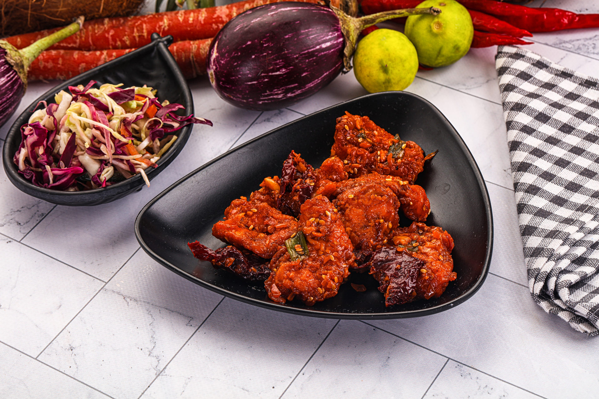 Overhead flat-lay of all ingredients for Crispy Senegalese Yassa Chicken Wings with Onion Marmalade laid out on a kitchen surface.