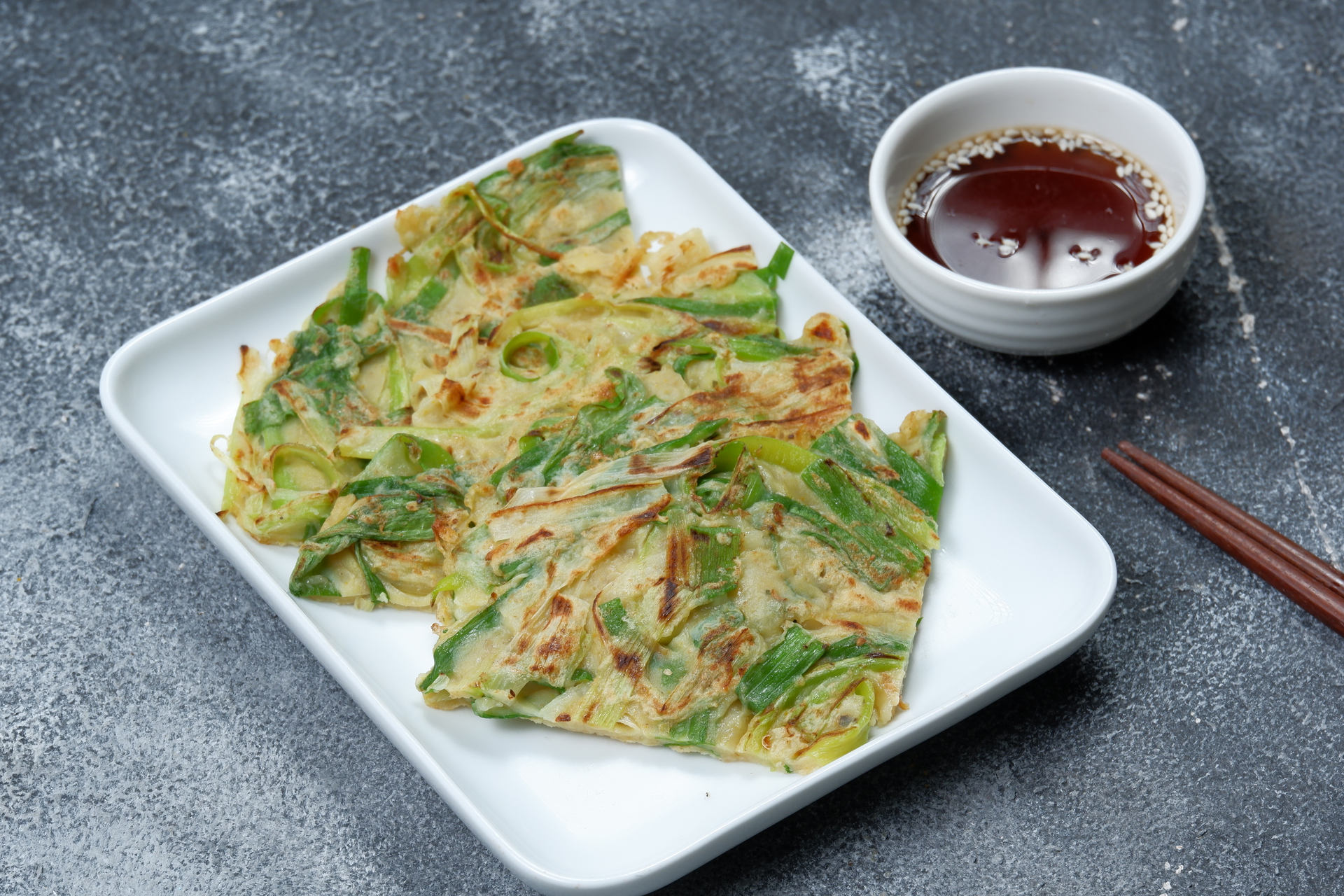 Overhead flat-lay of all ingredients for Crispy Taiwanese Scallion Pancakes with Soy Chili Dip laid out on a kitchen surface.