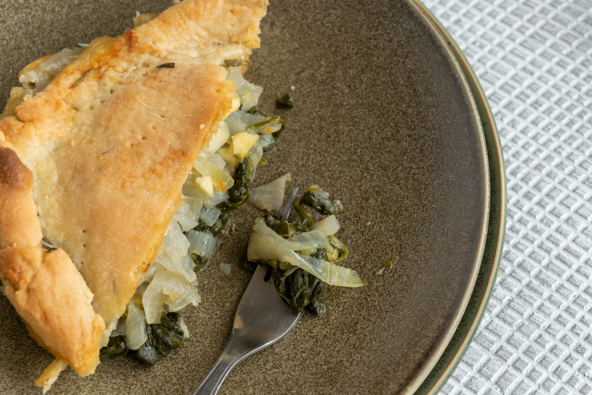 Overhead flat-lay of all ingredients for Croatian Soparnik with Swiss Chard and Onion laid out on a kitchen surface.