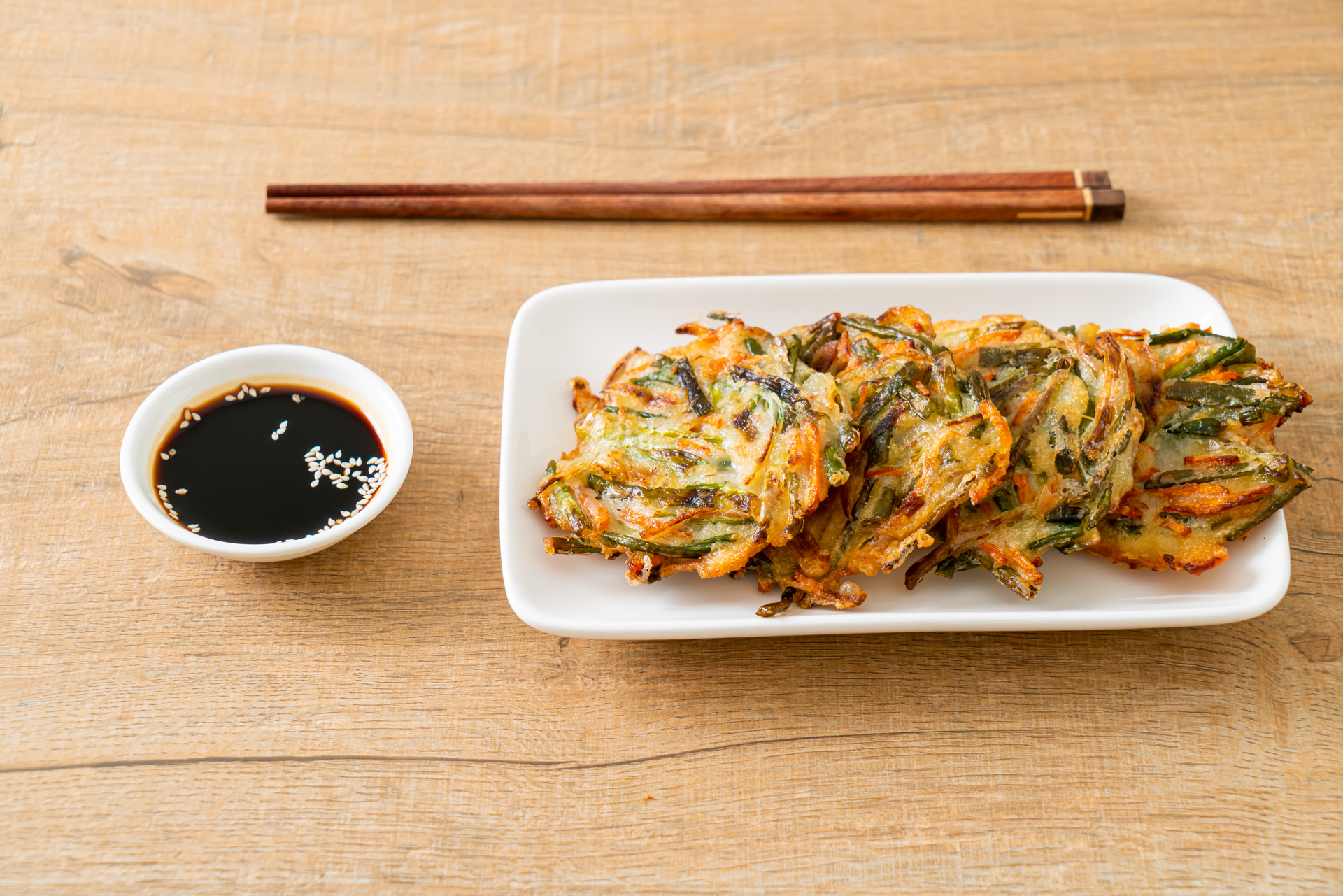 Overhead flat-lay of all ingredients for Crunchy Korean Kimchi Tempura with Sesame Dip laid out on a kitchen surface.