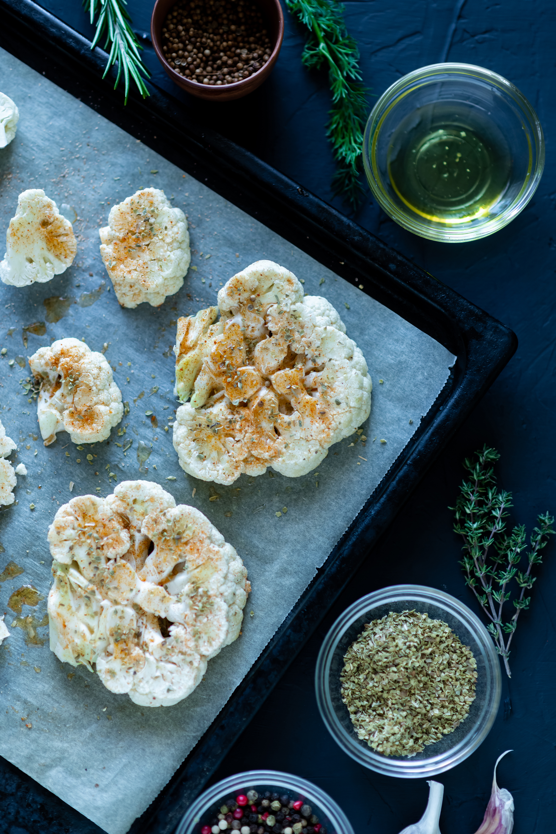 Overhead flat-lay of all ingredients for Crunchy Moroccan Za'atar Cauliflower Bites with Lemon Tahini laid out on a kitchen surface.