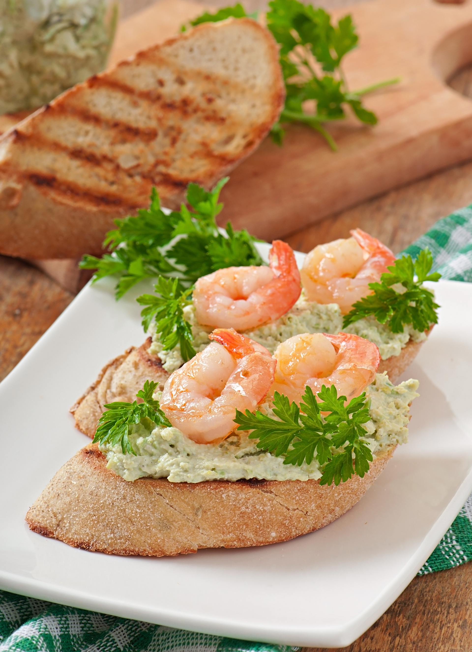 Overhead flat-lay of all ingredients for Crunchy Swedish Smörgåstårta with Prawns and Lemon Zest laid out on a kitchen surface.