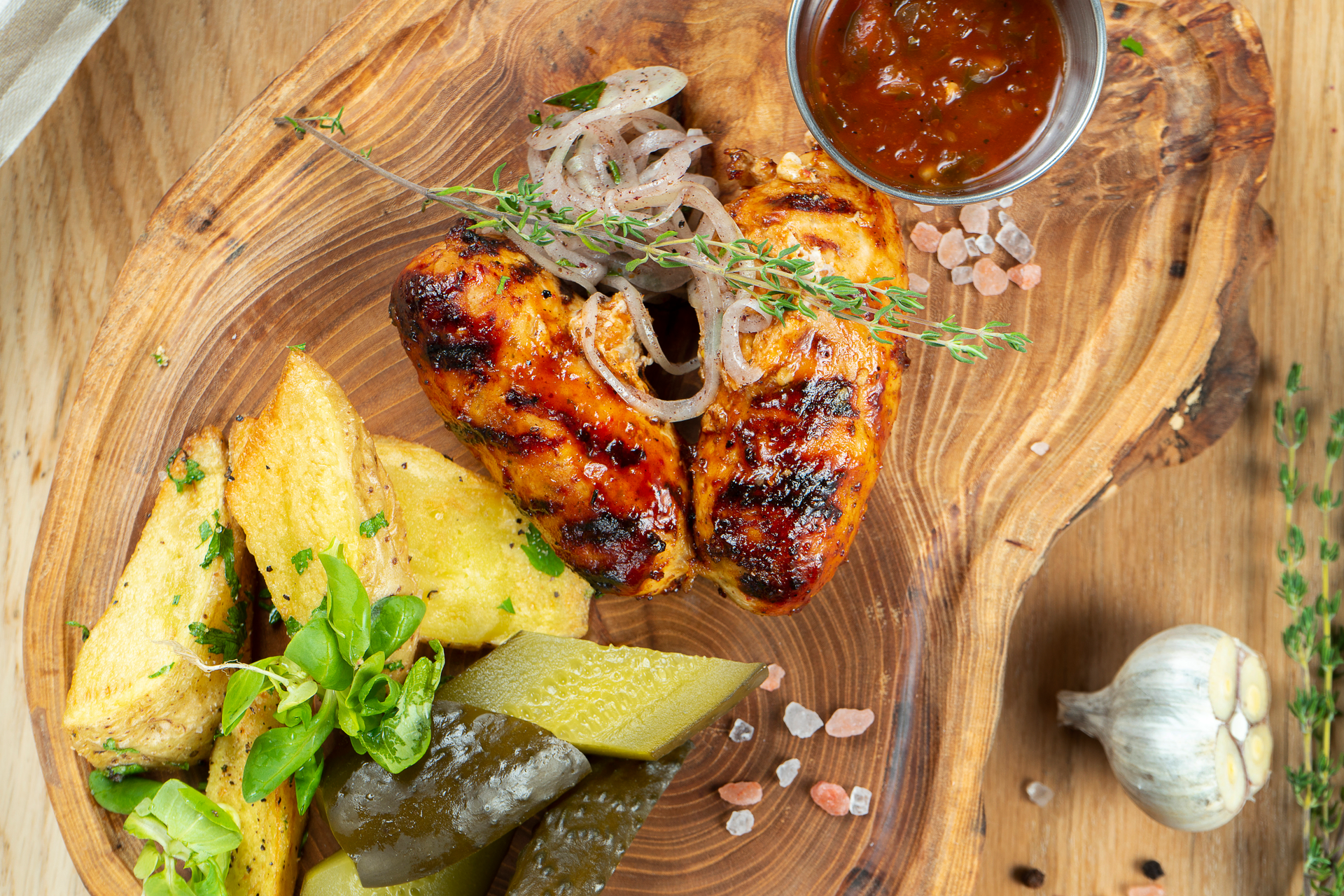 Overhead flat-lay of all ingredients for Cuban Citrus-Marinated Roast Chicken with Garlic Mojo laid out on a kitchen surface.