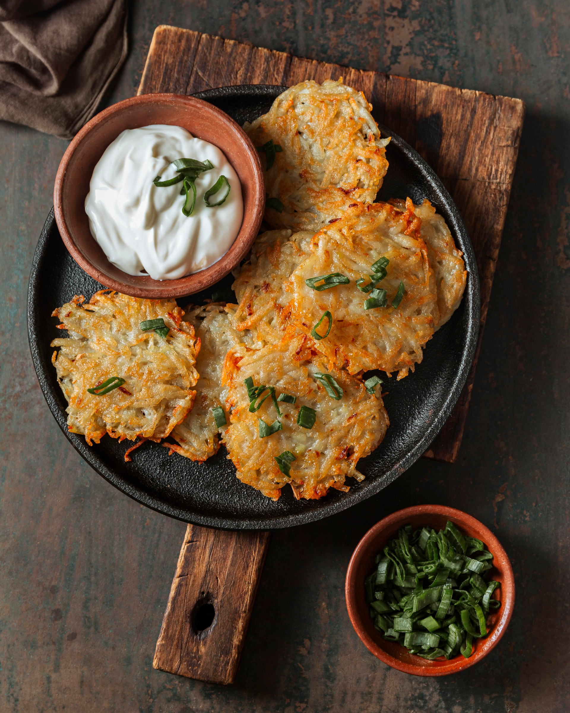 Overhead flat-lay of all ingredients for Cuban Malanga Fritters with Cilantro Aioli laid out on a kitchen surface.