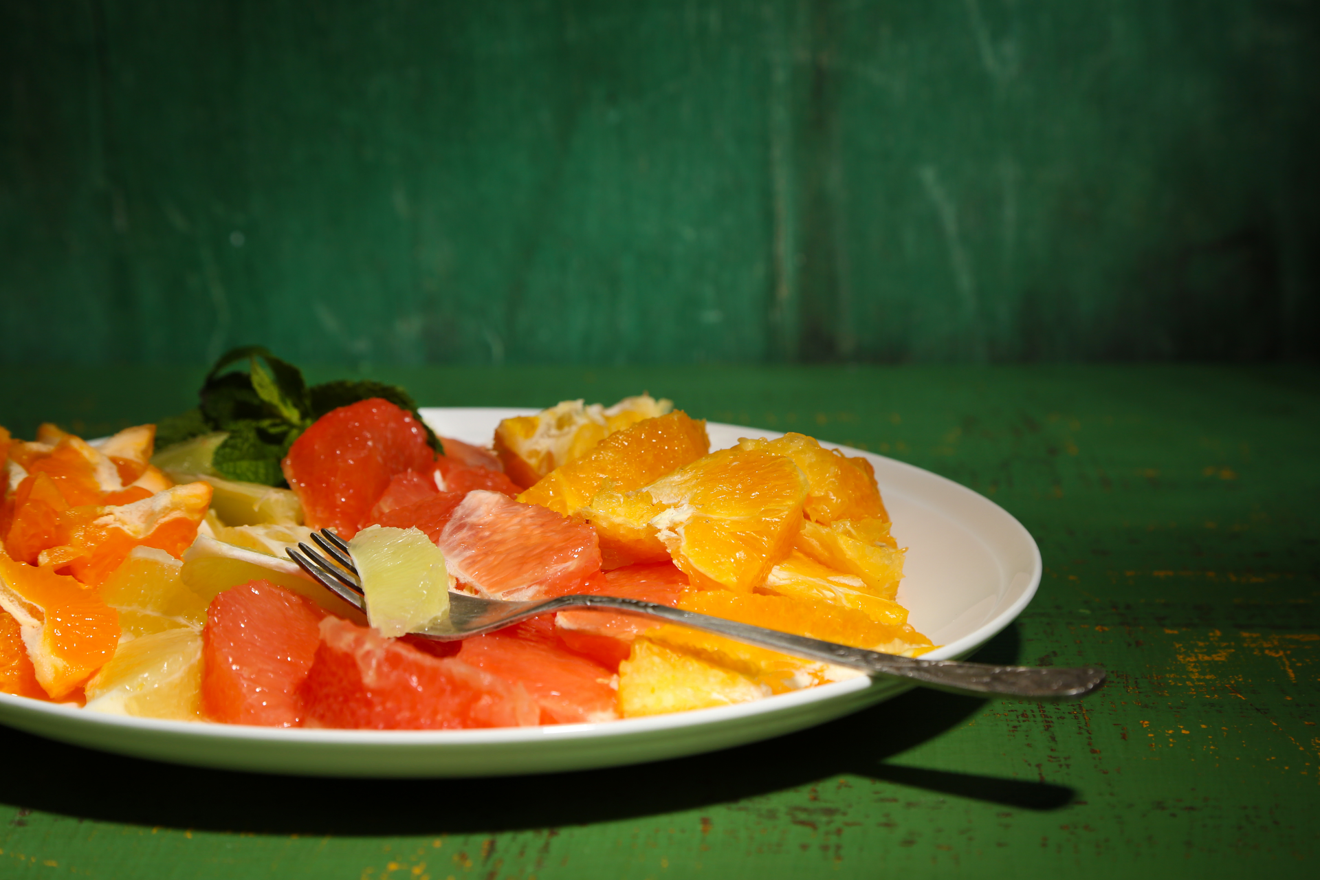 Overhead flat-lay of all ingredients for Cuban Yuca con Mojo with Garlic and Citrus laid out on a kitchen surface.